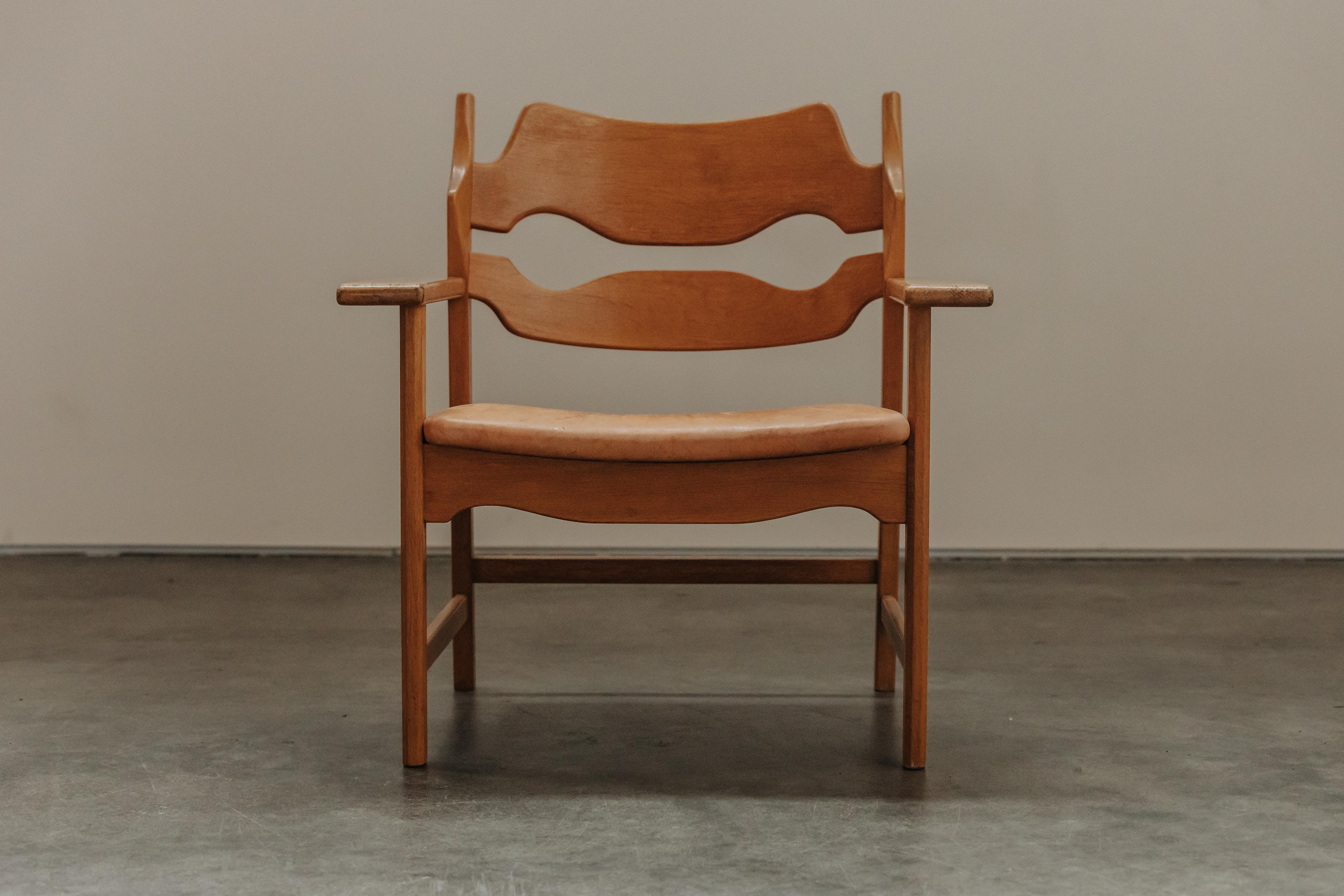 Vintage Henning Kjaernulf Razor Lounge Chair in Oak From Denmark, Circa 1960s.  Solid oak from with a cognac leather upholstered seat.  Nice patina and use.