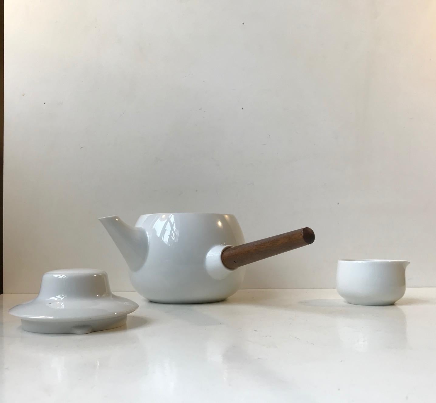 Important design by Henning Koppel exhibited at the British Museum and Museum of Modern Art in New York. This set consist of a milk/cream jug and the Koppel Characteristic teapot with its tapered handle in solid teak. It is called Form 24 and was