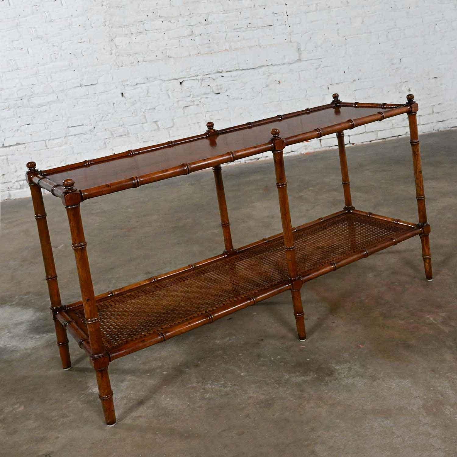 Stunning Late 20th Century Henredon Campaign or Hollywood Regency style faux bamboo & cane sofa table. Beautiful condition, keeping in mind that this is vintage and not new so will have signs of use and wear. There are no outstanding flaws that we