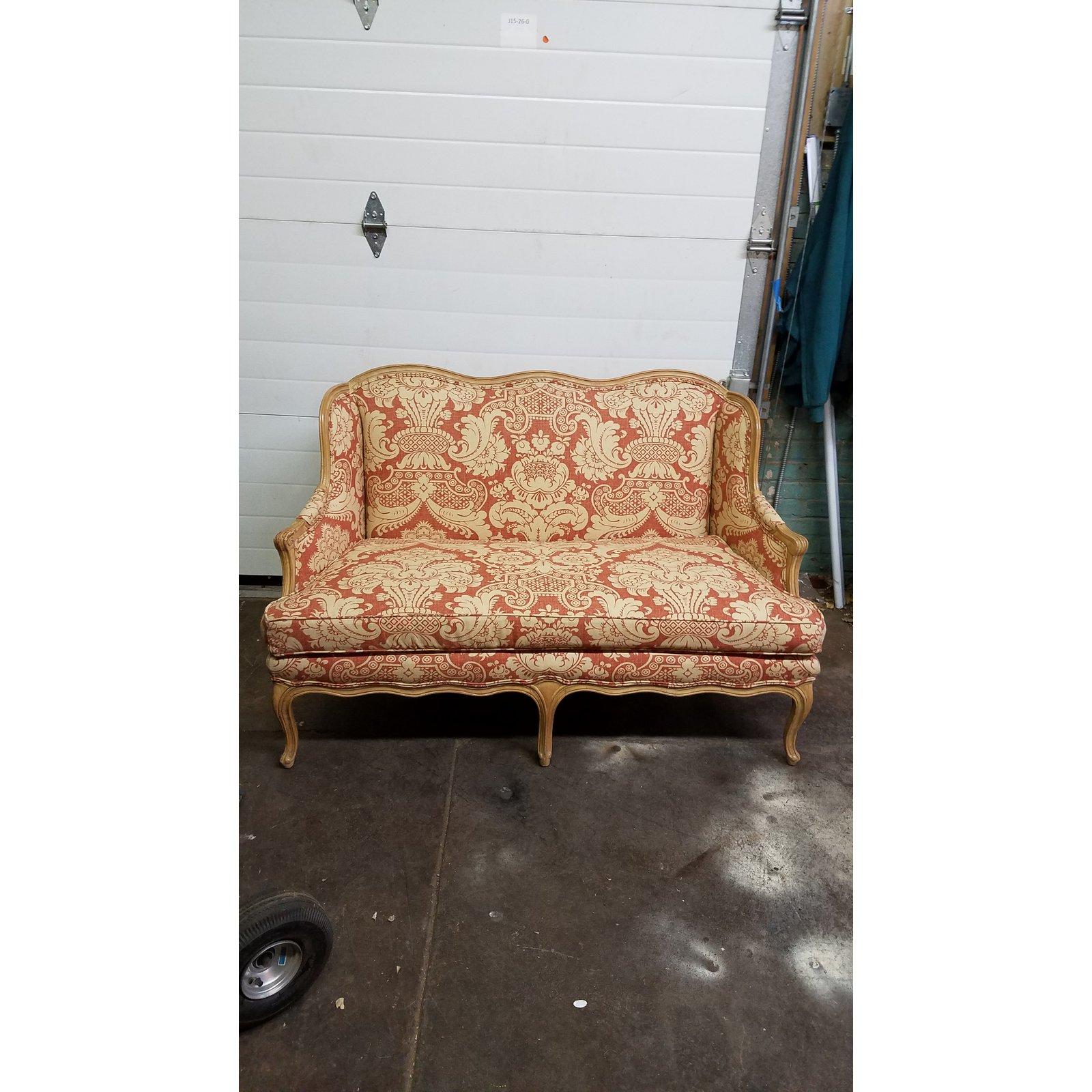 Great looking settee loveseat with new upholstery in ivory and burnt orange printed linen damask pattern with a light texture. The frame is a beautifully carved natural toned fruit wood. Henredon is know for quality 8 way hand tied construction with