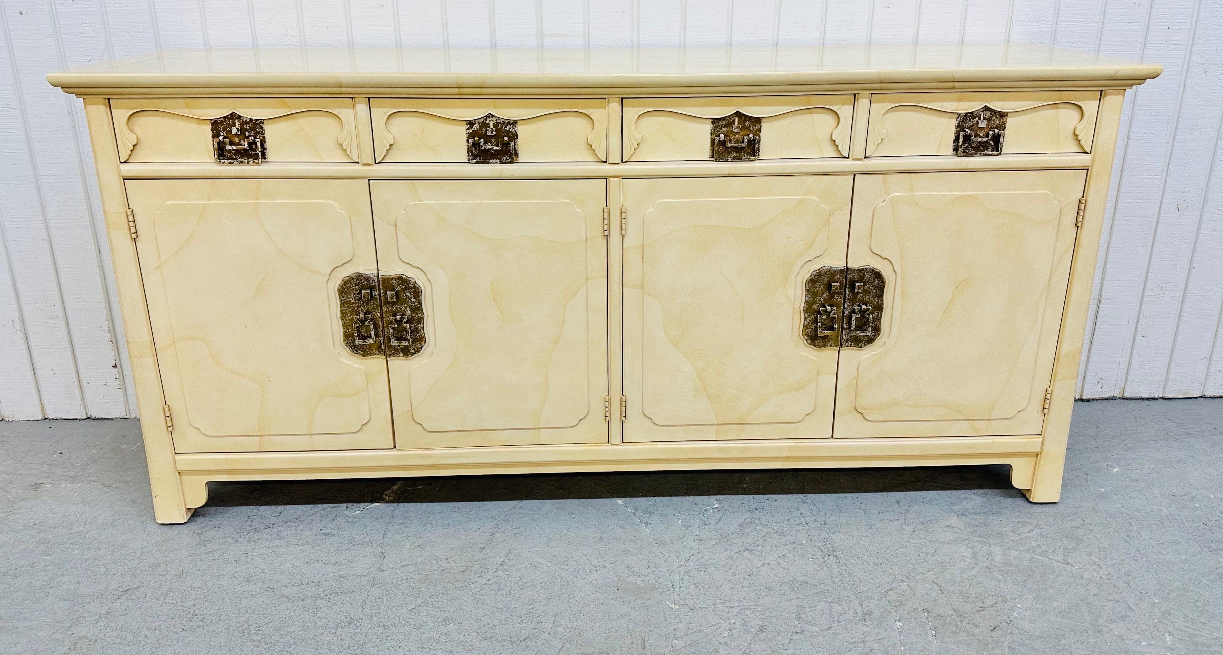 This listing is for a vintage Henredon Ivory Lacquered Sideboard. Featuring an Asian inspired design, four drawers, four doors that open up to storage space, original brass hardware, and a beautiful lacquered ivory finish.