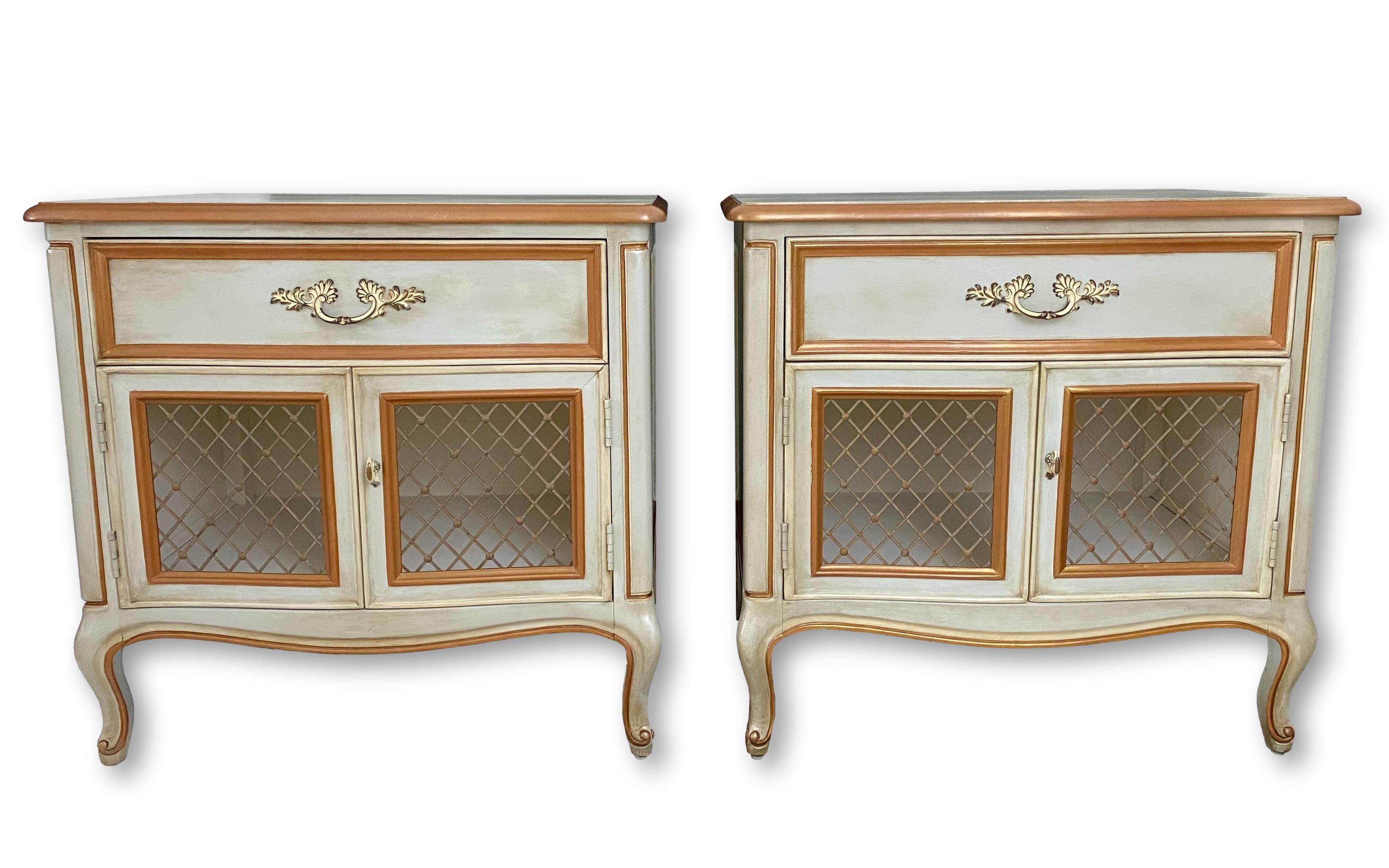 A pair of 1970's French Louis XV provincial style nightstands by Henredon. Refinished in pale blue/green with gold & cream details, pearlescent highlights, wax distressing and a smooth satin finish; brass hardware.

Dimensions: 26