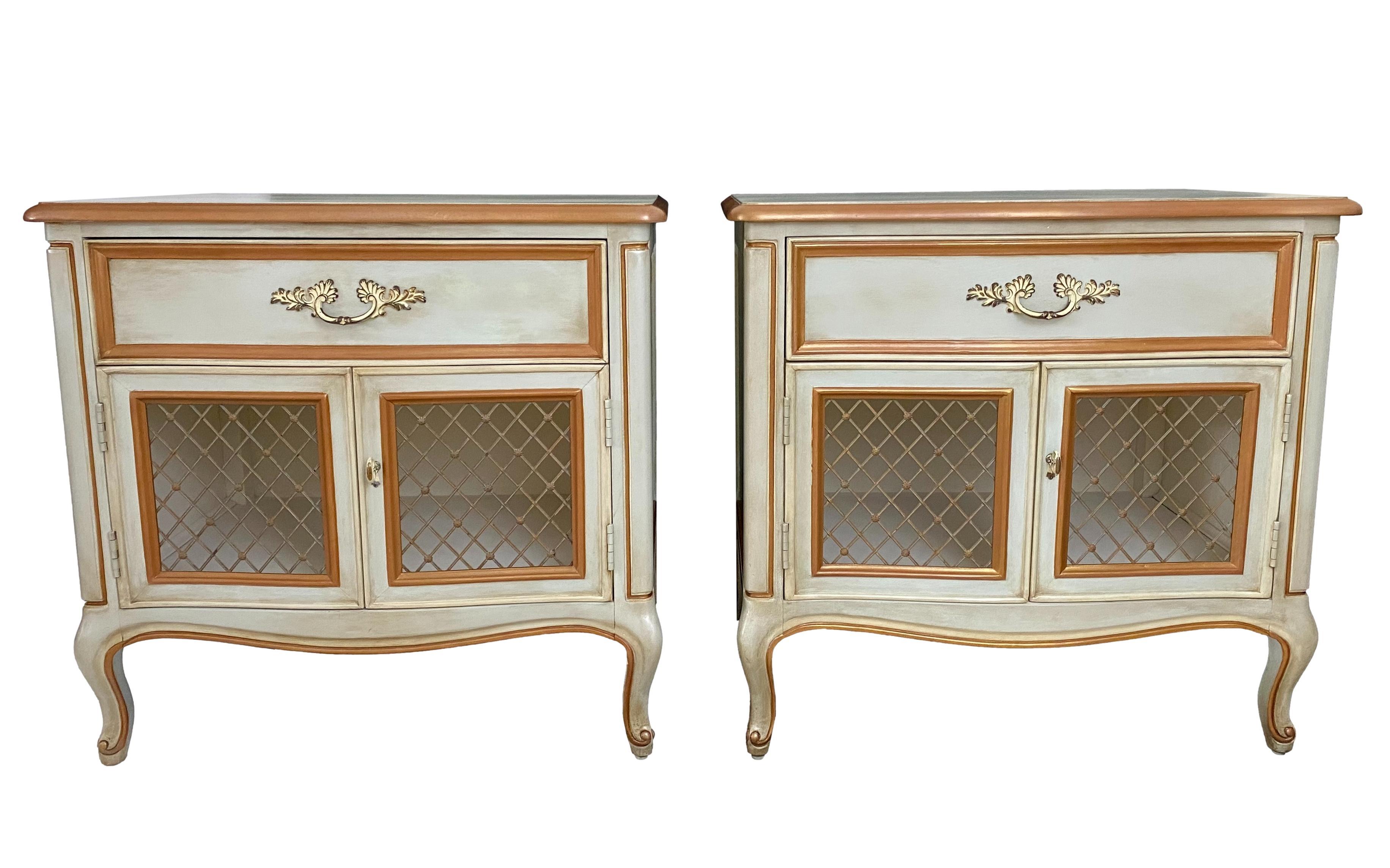 A pair of 1970's French Louis XV provincial style nightstands by Henredon. Refinished in pale blue green with gold & cream details, pearlescent highlights, wax distressing and a smooth satin finish; brass hardware.

Dimensions: 26