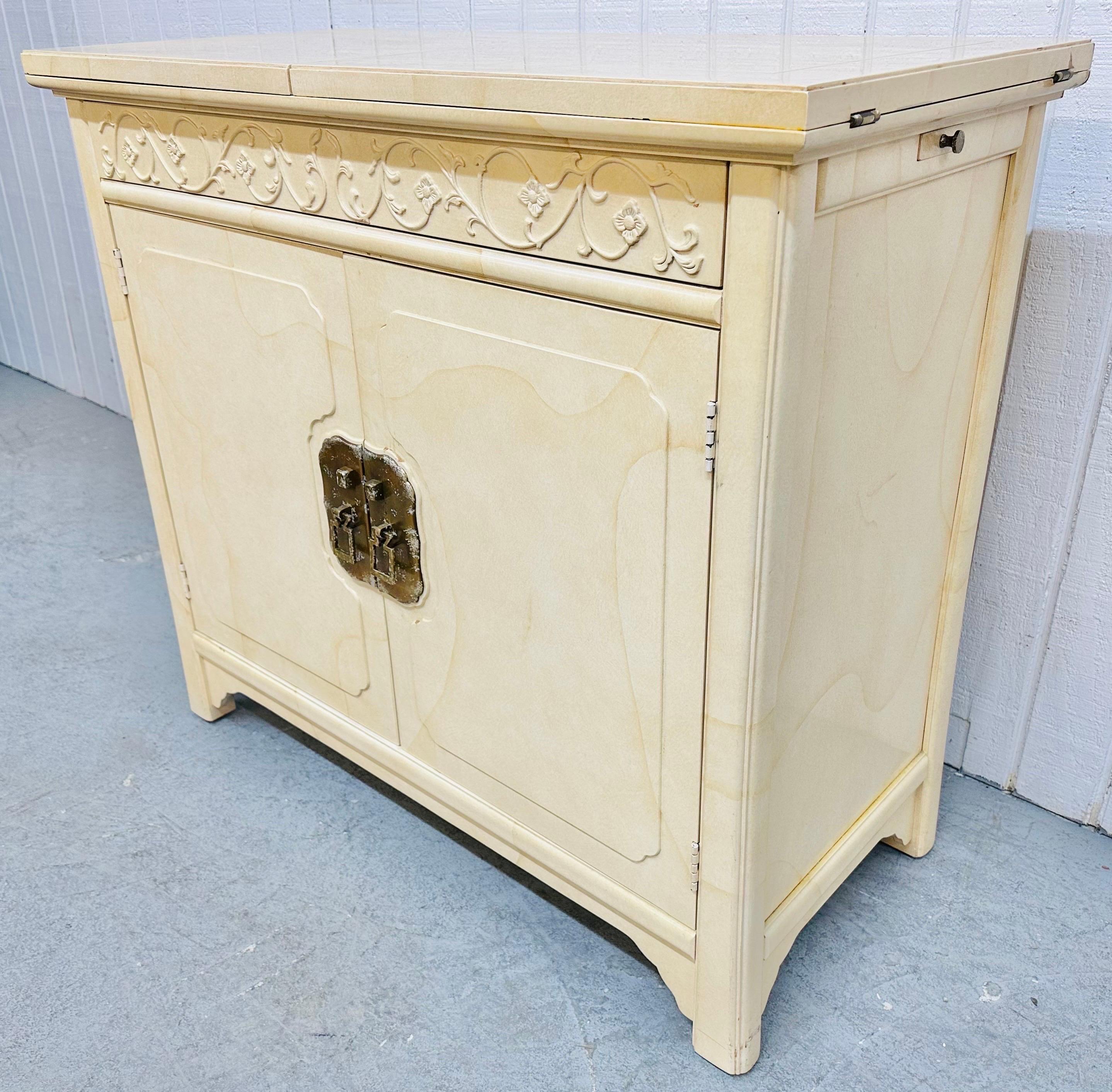 This listing is for a Vintage Henredon “Plan 2” Lacquered Bar Cabinet. Featuring a flip-top 76” L serving area, hidden push-to-open drawer, two doors that open up to storage space, original brass hardware, oriental inspired design, and a beautiful