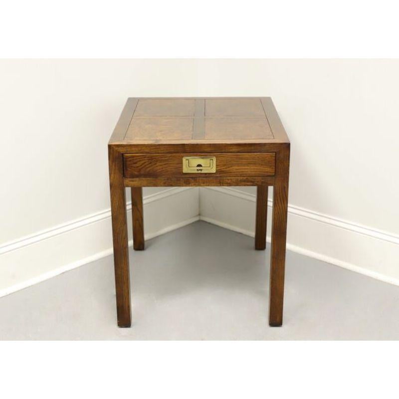 A Campaign style end table by Henredon, from their Scene One Collection. Walnut and burlwood with brass hardware. Features burlwood inlaid top and one dovetailed drawer. Made in the USA, circa 1980.

Measures: 22W 27D 25.25H

Very good condition