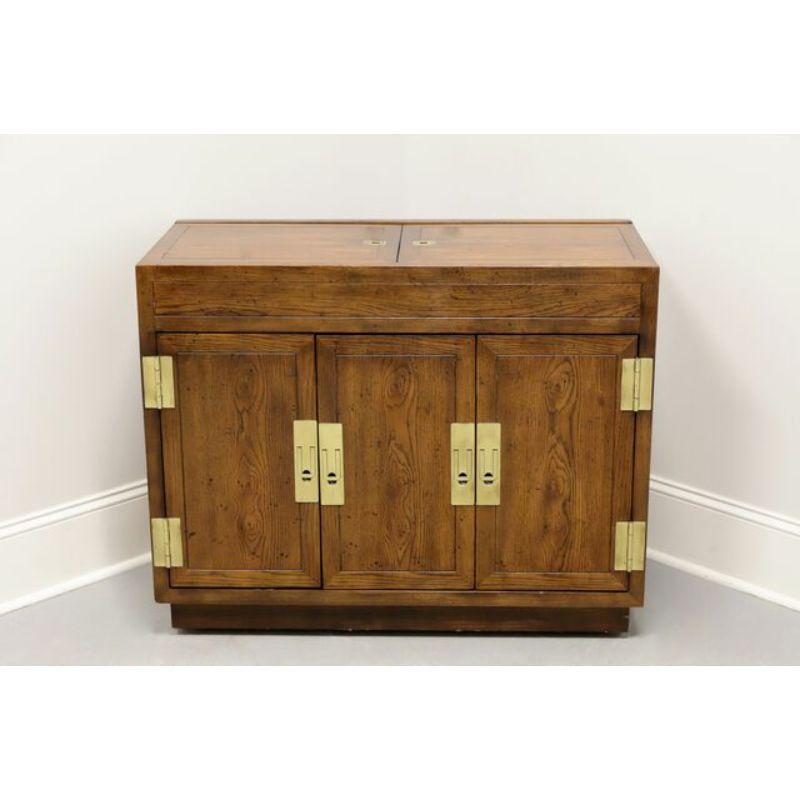 A Campaign style server by Henredon, from their Scene One Collection. Fruitwood with brass hardware and formica like top under flip out top. Features the flip out top, tri-fold doors revealing one dovetail drawer and an interior storage area with