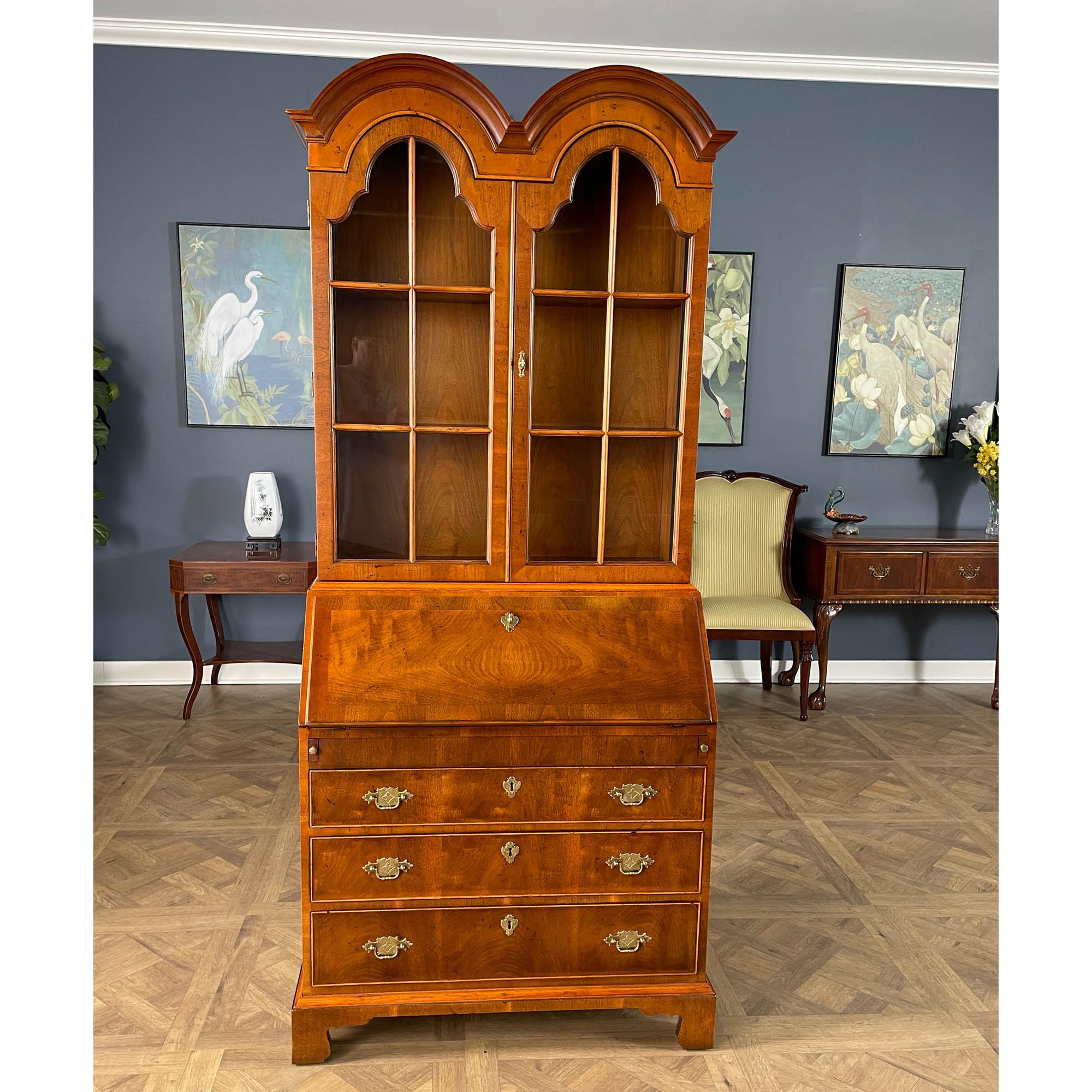 A Vintage Henredon Secretary Desk brought to you by Niagara Furniture. This desk is impressive in both it’s design and scale. Made of beautifully grained walnut, the secretary bookcase features double domed arches on the top as well as adjustable