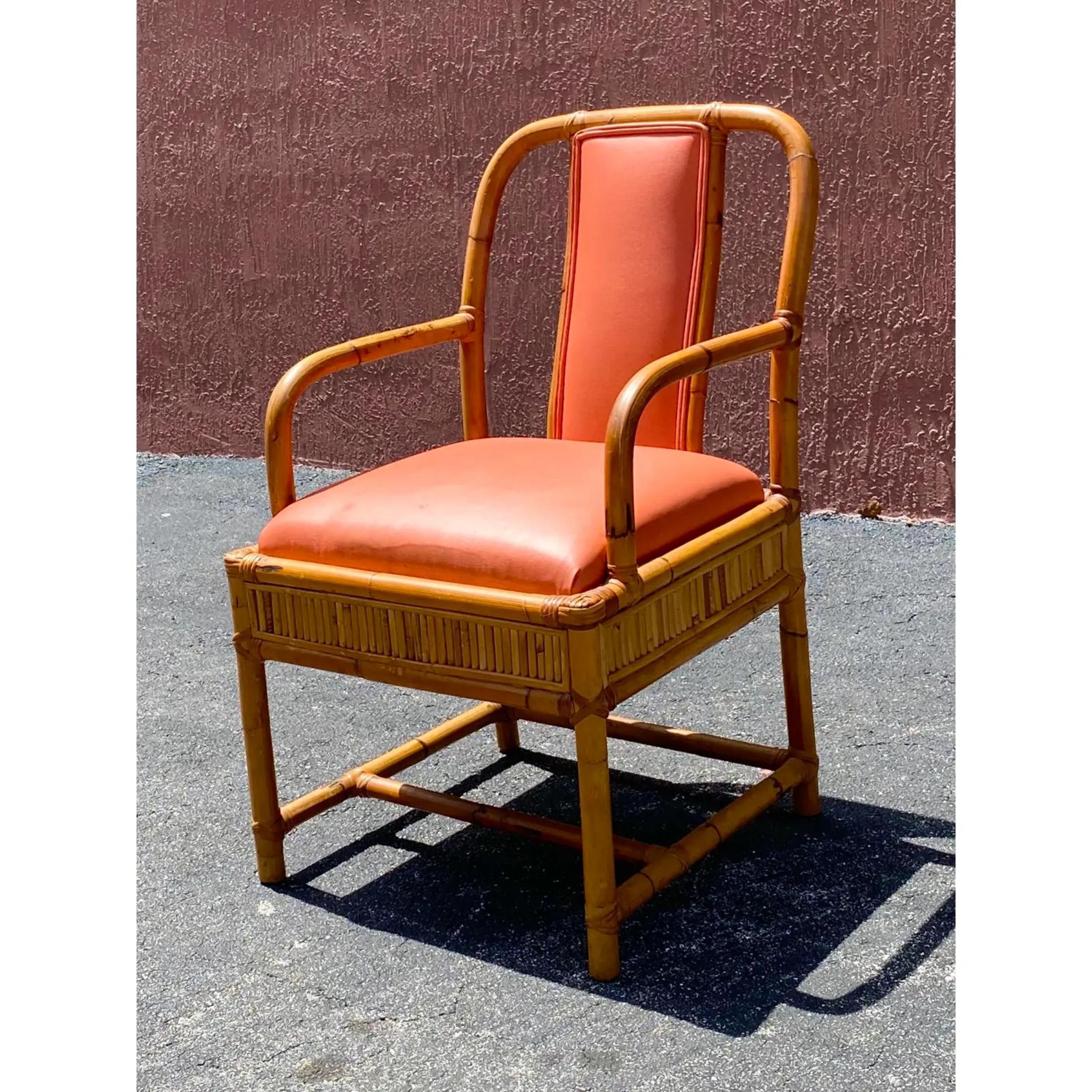 Fantastic vintage Henry Olko bamboo arm chair. The seat is done in a beautiful coral leather. The chair has beautiful bamboo pattern work all along the perimeter.