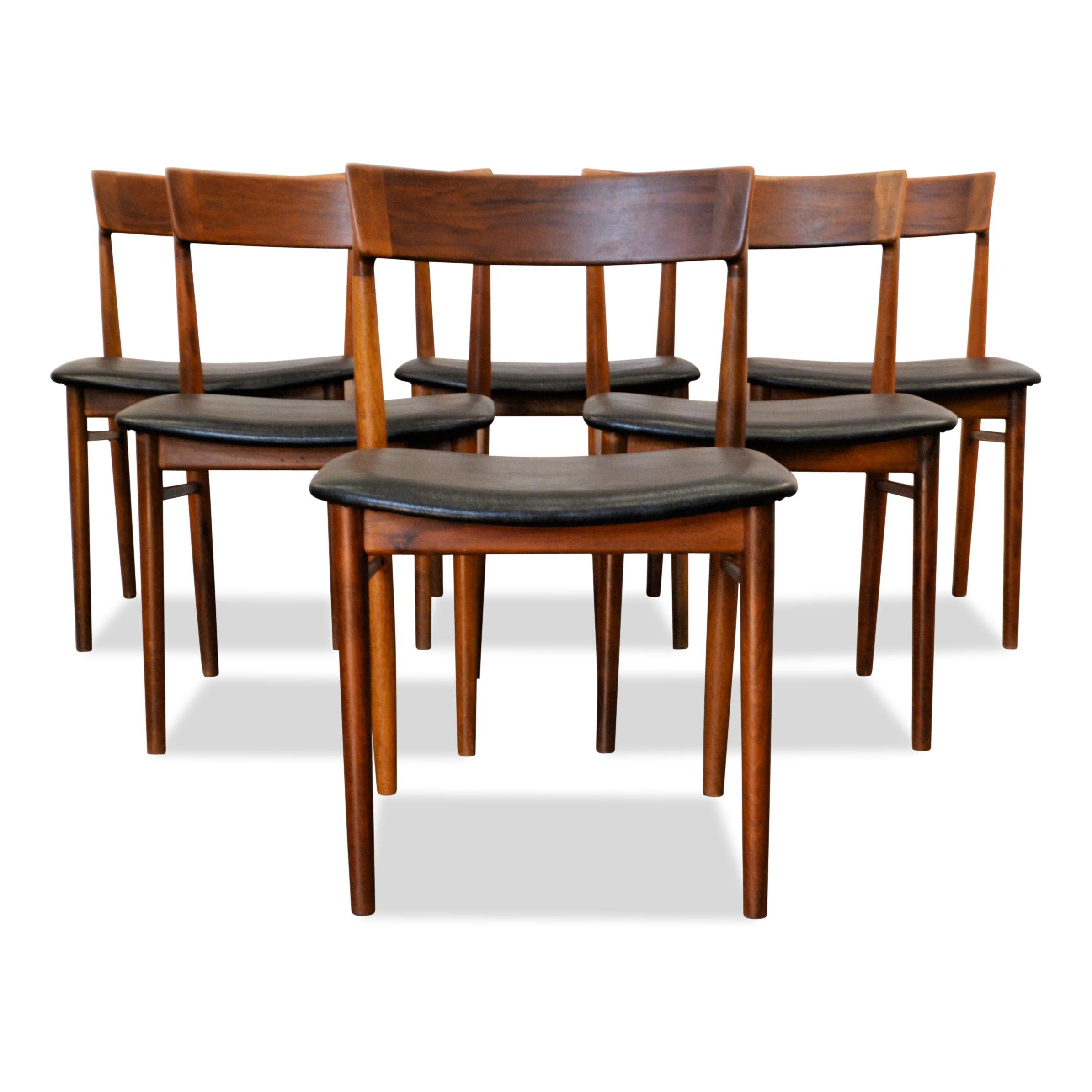 Set of six Danish vintage chairs designed by Henri Rosengren for Brande Møbelindustri. These stylish, high quality design chairs feature a typically Danish organic design, solid teak frames and a beautiful new black skai leather upholstery and new