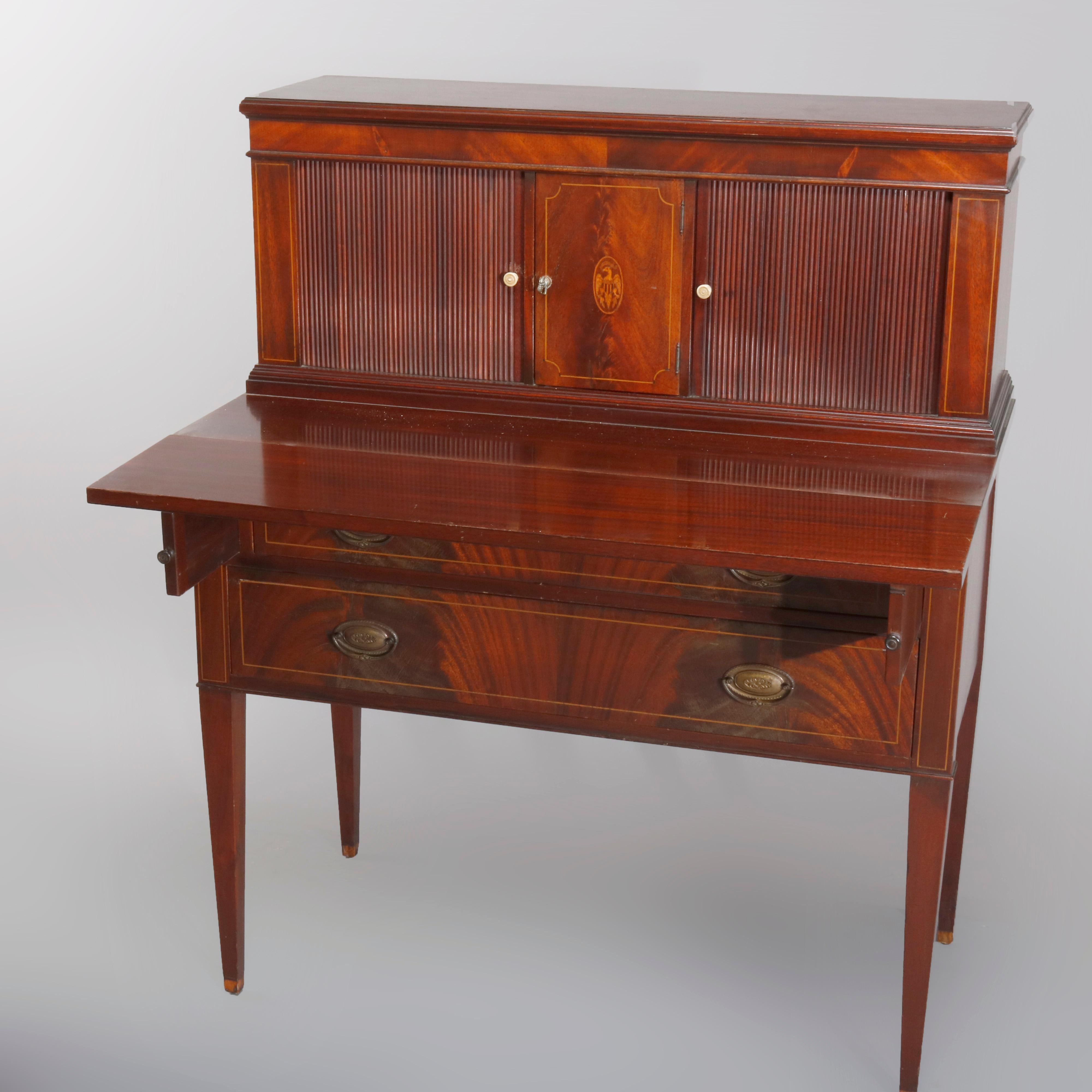 A vintage Hepplewhite style secretary offers flame mahogany construction with tower having tambour doors flanking central panel with satinwood inlaid medallion surmounting case with drop front desk and two long drawers, raised on square and straight