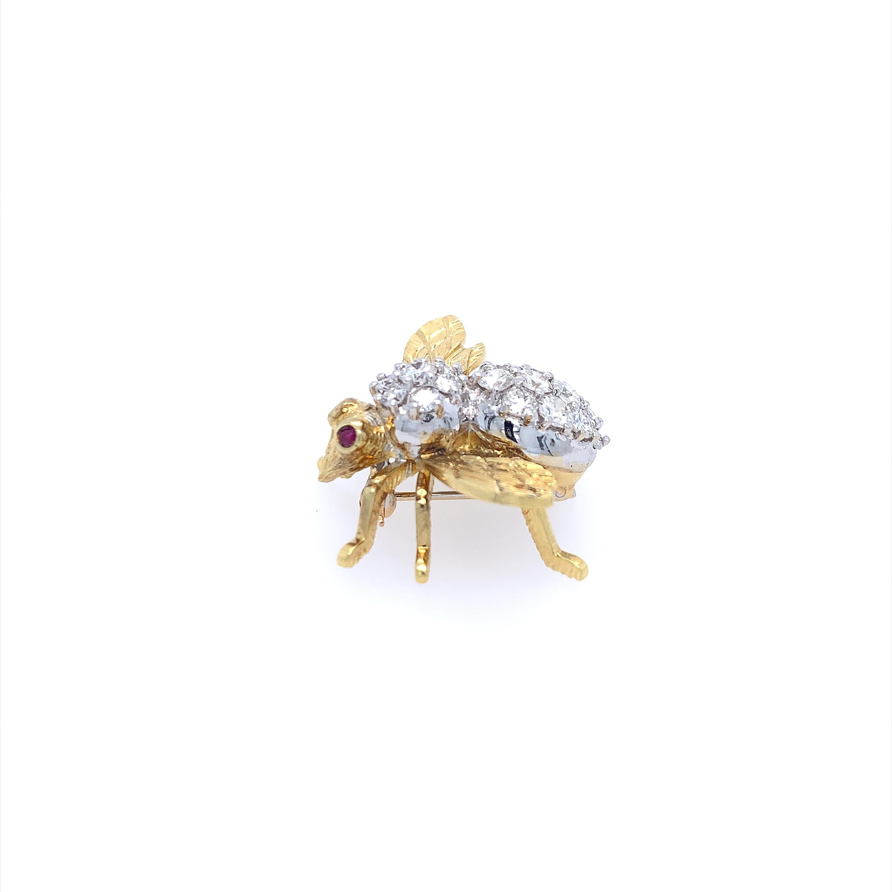 A magnificent Herbert Rosenthal Bee Brooch featuring 2.00 carats of diamonds embellished with bezel set ruby eyes. This 18K yellow and white gold brooch pin features a 3D life-like bee with a pin closure. Its body is encrusted with (19) nineteen