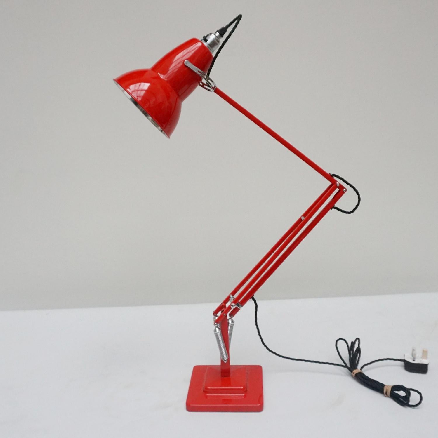 'Three-spring' chromed and polished red painted Anglepoise desk lamp by Herbert Terry & Sons. Two step base and perforated lamp shade. Original stamps to stem. The three spring Anglepoise lamp was first released by Herbert Terry &Sons in 1935.