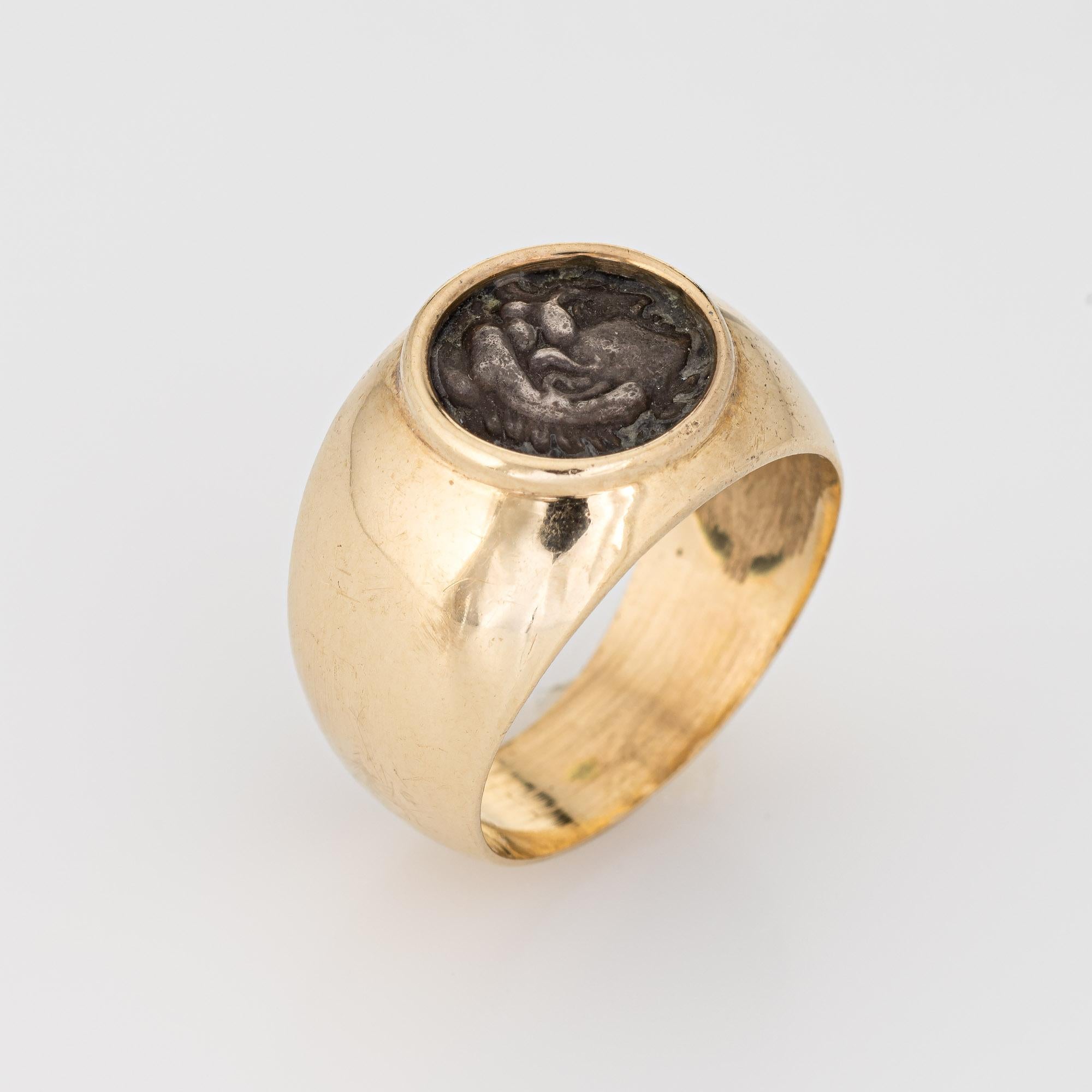 Stylish vintage Hercules ancient coin ring crafted in 14 karat yellow gold (circa 1960s to 1970s). 

Ancient coin measures 9mm diameter. 

The signet mount holds a silver ancient coin depicting Hercules (likely Greek or Roman origin) set into a