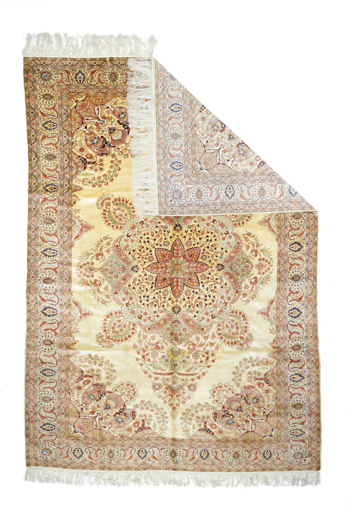 Vintage Herekeh rug measures 6'5'' x 9'6''. A lightly-toned, finely woven Turkish city small carpet in as strongly Kirman-influenced style. The sandy-straw semi-open field shows a complex medallion of flower sprays, boteh leaves, serrated sickle