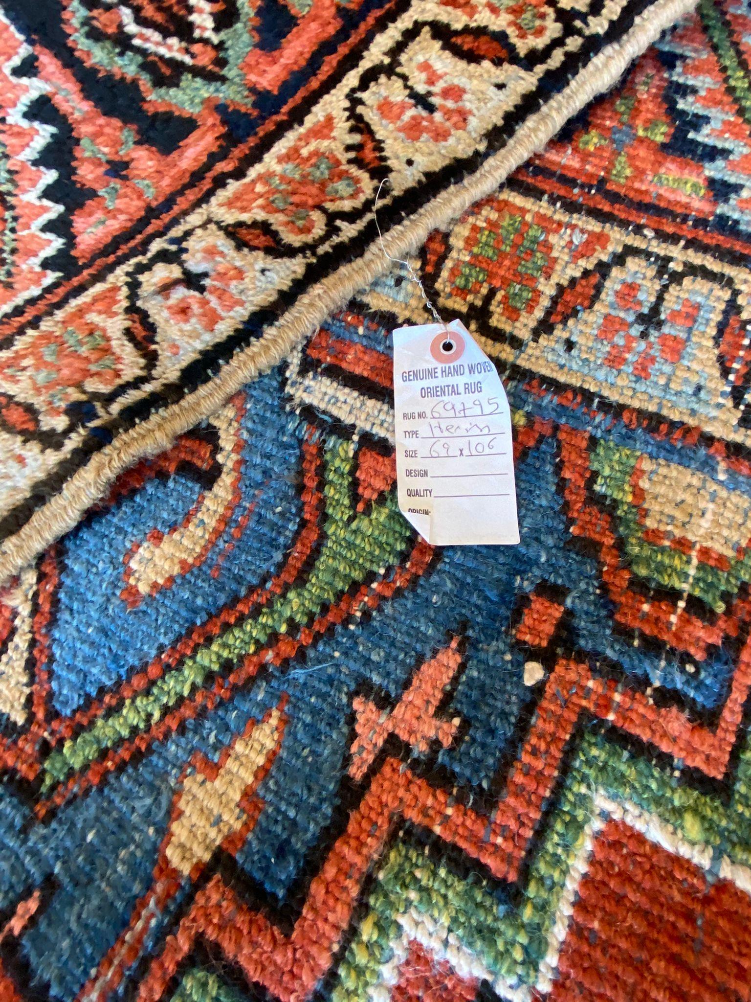 The Vintage Heriz Rug is a captivating masterpiece that showcases the richness and depth of Persian artistry. Its color palette, adorned with vibrant reds, deep blues, serene pale blues, creamy ivory, and earthy browns, creates a stunning visual