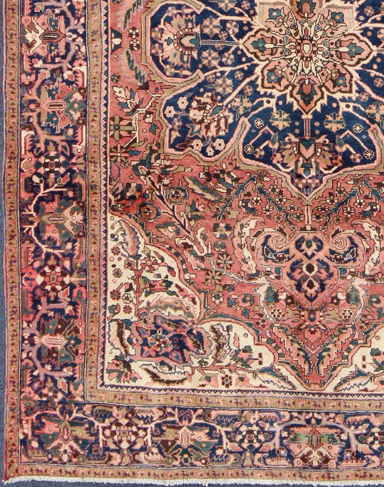 Semi Antique Heriz Persian Rug with Geometric Medallion in Rust and Blue, H-501-26, 1950’s Semi Antique Persian Heriz Rug-8'9 X 11'8
This magnificent antique Persian Heriz carpet from the mid-20th century bears an exquisite design rendered in