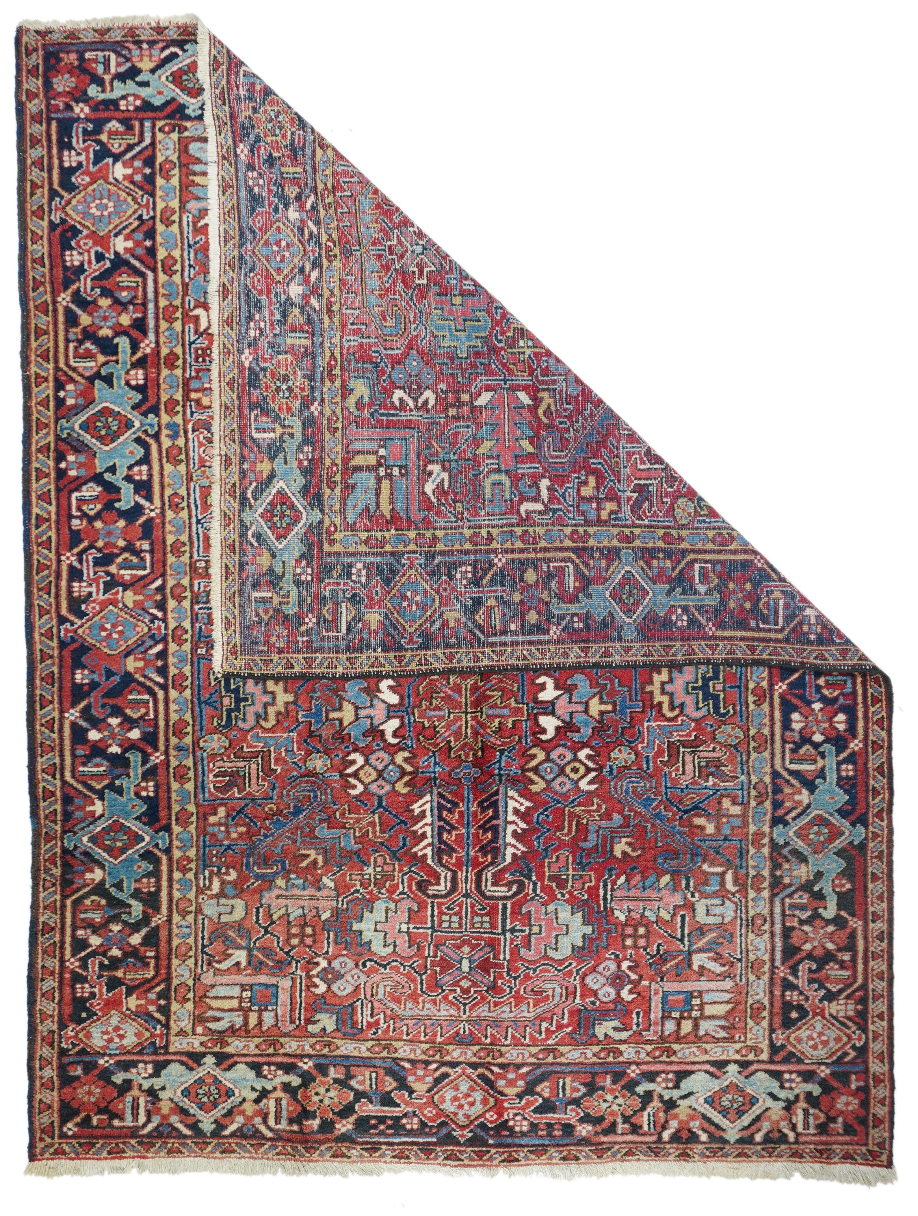 Vintage Heriz Rug 6'5'' x 8'3''. This Heriz/Mehriban large scatter/small carpet shows a red field dominated by a quartet of four curled ivory sawtooth leaves, feathery, oblique polychrome corner flowers. Strip style navy main border of geometric