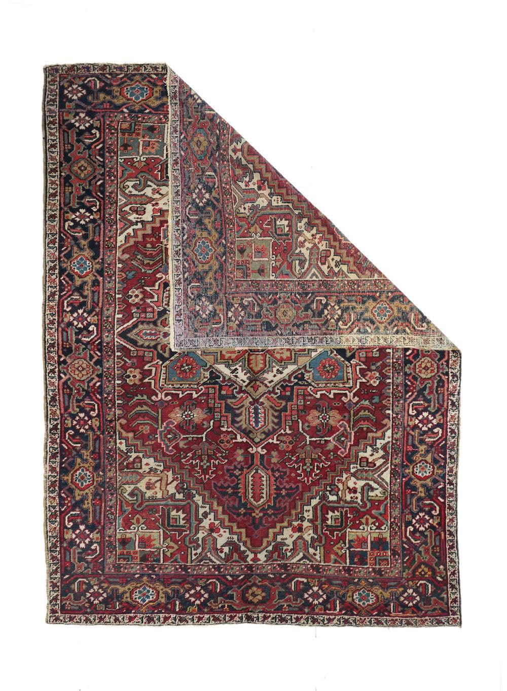 Vintage Heriz Rug 6'7'' x 9'0''. This moderately coarse, but well-woven rustic carpet shows a saturated red field centred by a navy and cream palmette medallion and associated navy pendants. 12 lobe salmon-rose sub-medallion. Cream corners with red