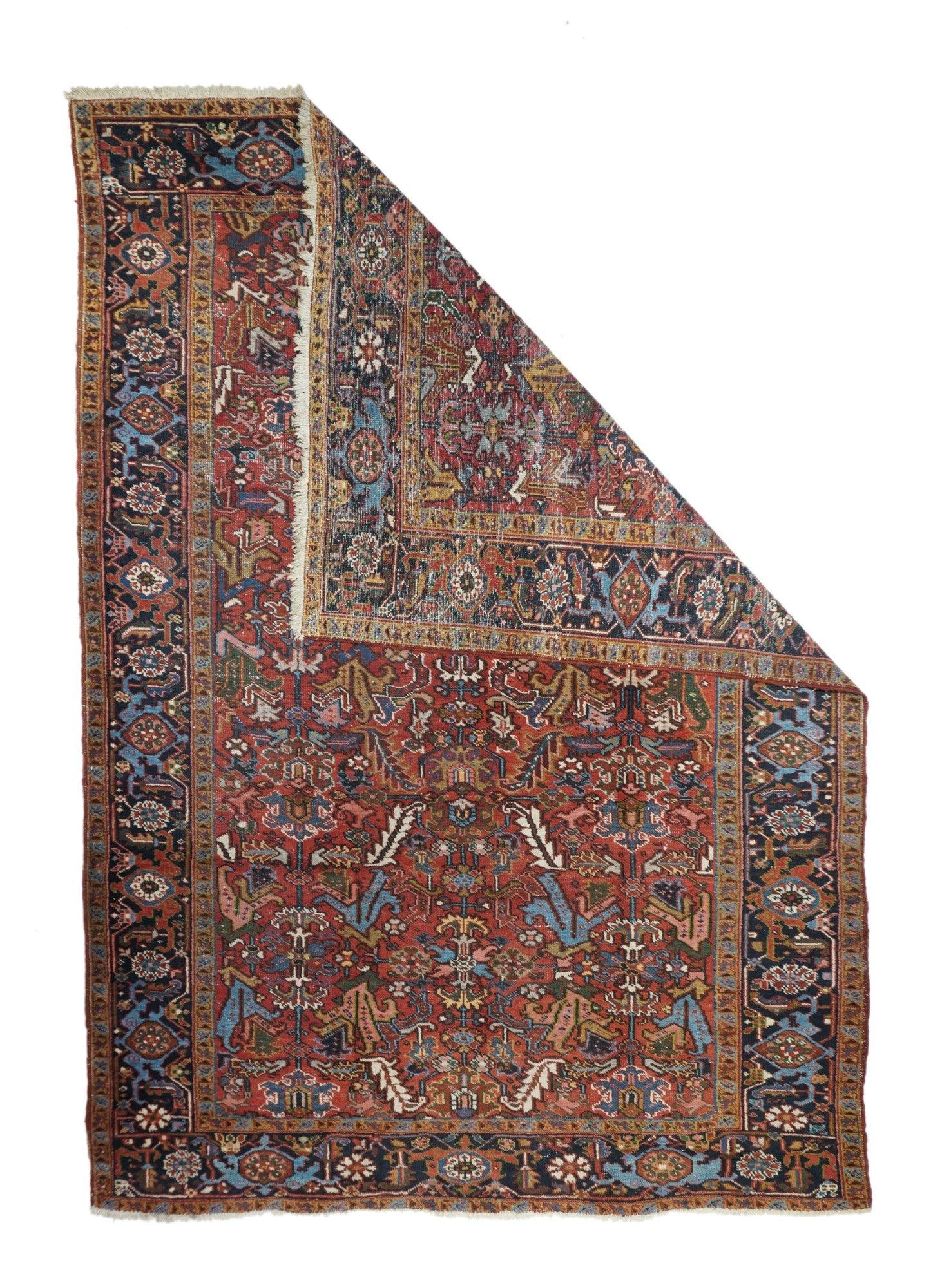 Vintage Heriz Rug 7'4'' x 10'8''. The madder red field hosts a centred, allover design of barbed leaves, radiating simple blossoms and eccentric profile palmettes, accented in ecru, light blue, mustard and teal. Navy strip-style main border with