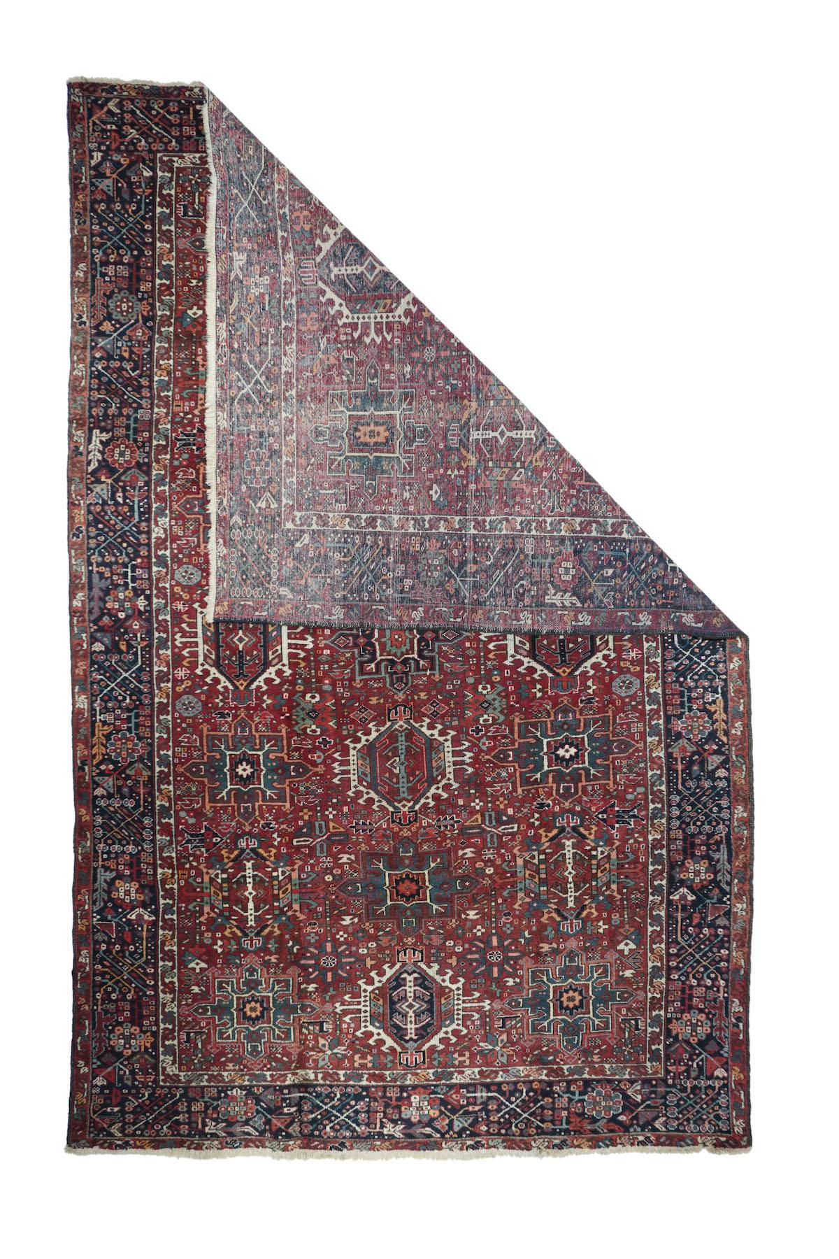 Vintage Heriz Rug 7'5'' x 11'2''. Three columns of characteristic Karaja octogramme and hexagon medallions in green and ecru respectively decorate the red field, while a scatter of smaller, semi-geometric elements closely fills in. Navy border with