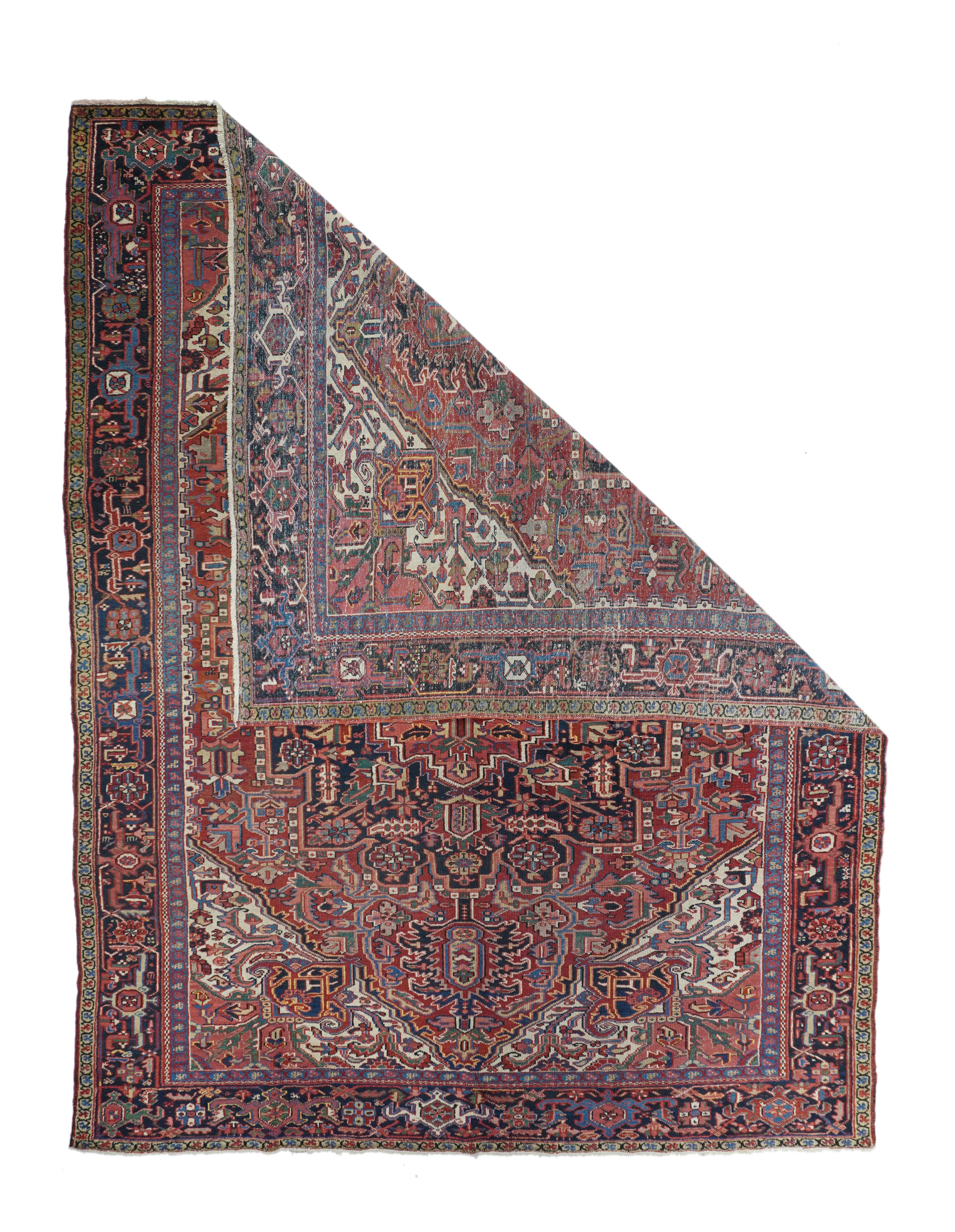 Vintage Heriz Rug 8'3'' x 11'2''. This Ahar-quality NW Persian rustic weaving shows a madder red laterally notched subfield on a cream field with palmette corner projections and volute forked arabesques. Elaborately stepped navy medallion with