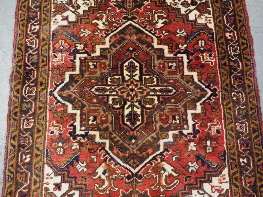 Vintage North West Persian Heriz rug of classic design
About 60 years old

A good rug of small size with a single medallion on a soft red ground This is a well made rug with thick heavy pile

Excellent condition with very slight even wear and full