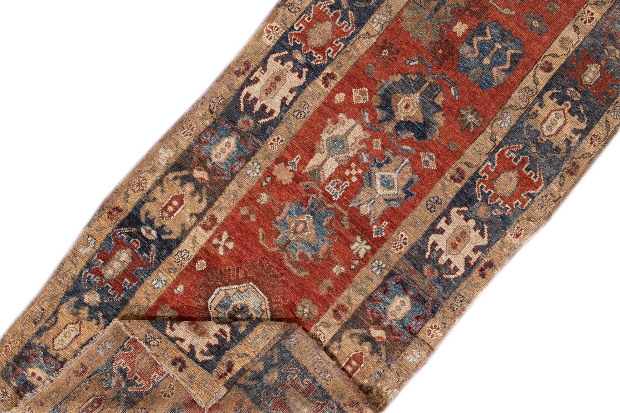 Beautiful vintage Heriz wool runner with a red field, the fame of navy-blue. This rug has multi-color accents in an all-over geometric design.

This rug measures 3' 7
