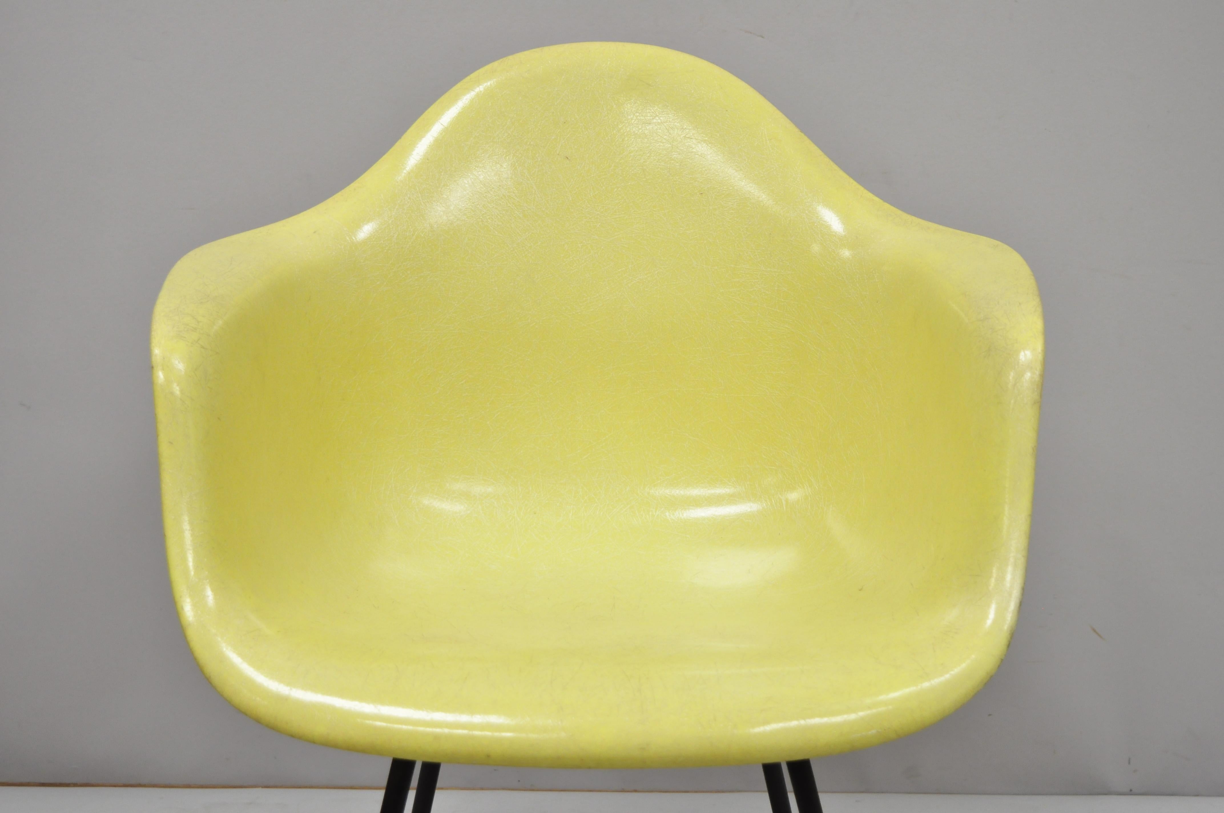 Vintage Herman Miller yellow fiberglass shell armchair H base (B). Item includes a yellow fiberglass shell, metal H-frame base, very nice vintage item, quality American craftsmanship, no remaining label, circa mid-20th century. Measurements: 27