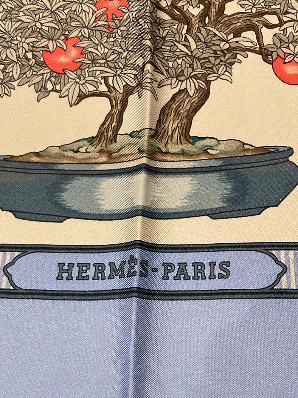 Vintage Hermes Bonsai Silk Scarf in excellent condition. Original silk screen design c1991 by Catherine Baschet features an array of ornate bonsai trees with black and gray illustrated leaves and details and red, orange, coral and green foliage,