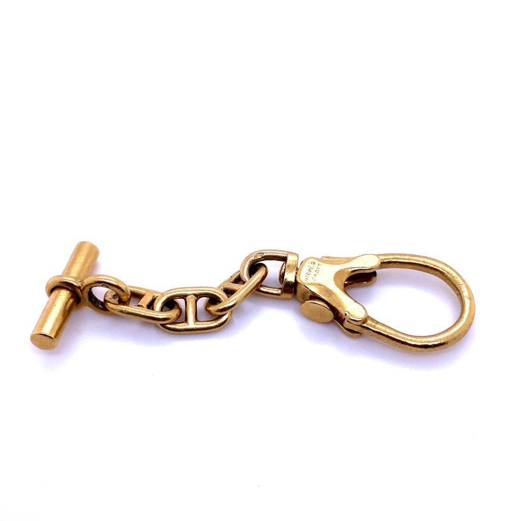 An Hermès Chaîne d'Ancre keyring in 18 karat yellow gold circa 1950.

This iconic and rare Hermès keyring is composed of 18 karat yellow gold oval links each with a bar spacer, to a circular or baton terminal, with a classic T-bar fitting. 
Signed