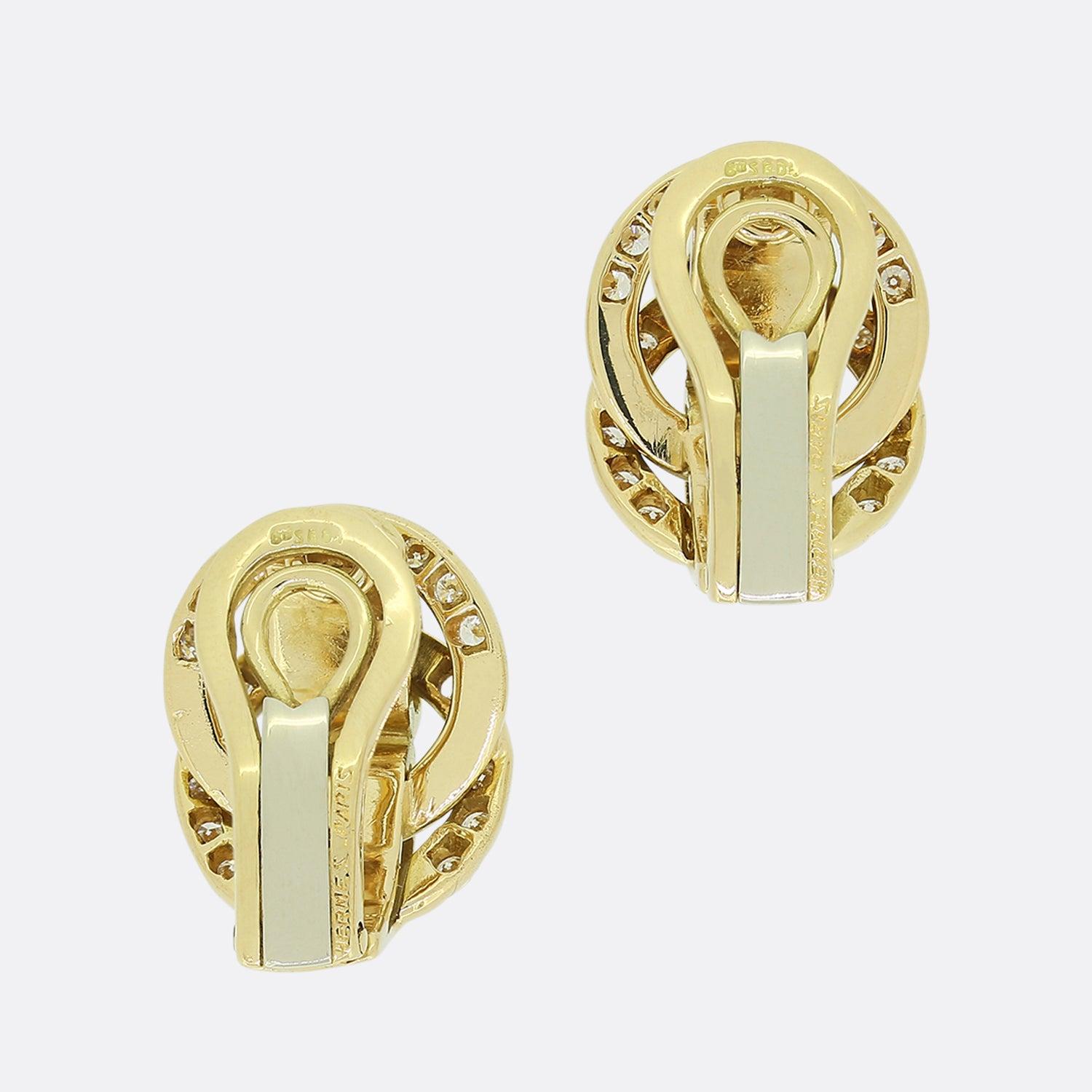 This is a beautiful pair of diamond clip earrings by the very well known designer Hermes. A matching pair, each set with nineteen transitional cut diamonds in open back settings, thirty eight in total with a combined approximate weight of 0.95