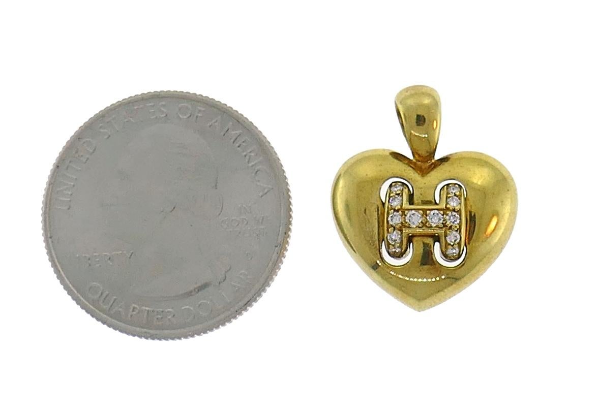 Cute heart charm pendant created by Hermes in France in the 1980s.
Made of 18 karat yellow gold and set with round brilliant cut diamonds (G-H color, VS1 clarity, total weight approximately 0.12 carat).
Measurements: 5/8 x 5/8 inch (1.7 x 1.5 cm)