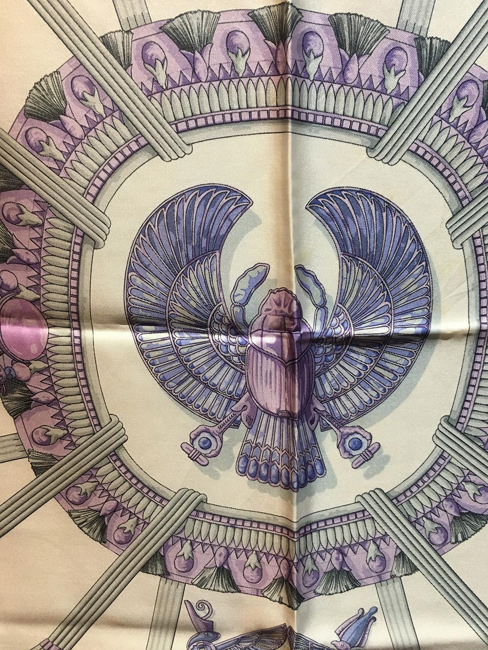 Vintage Hermes Egypte Silk Scarf c1970s in very good condition. Original silk screen design c1970 by Caty Latham features a centered scarab design in shades of purple surrounded by purple and grey Egyptian gems, trims, tassels, and animals with more