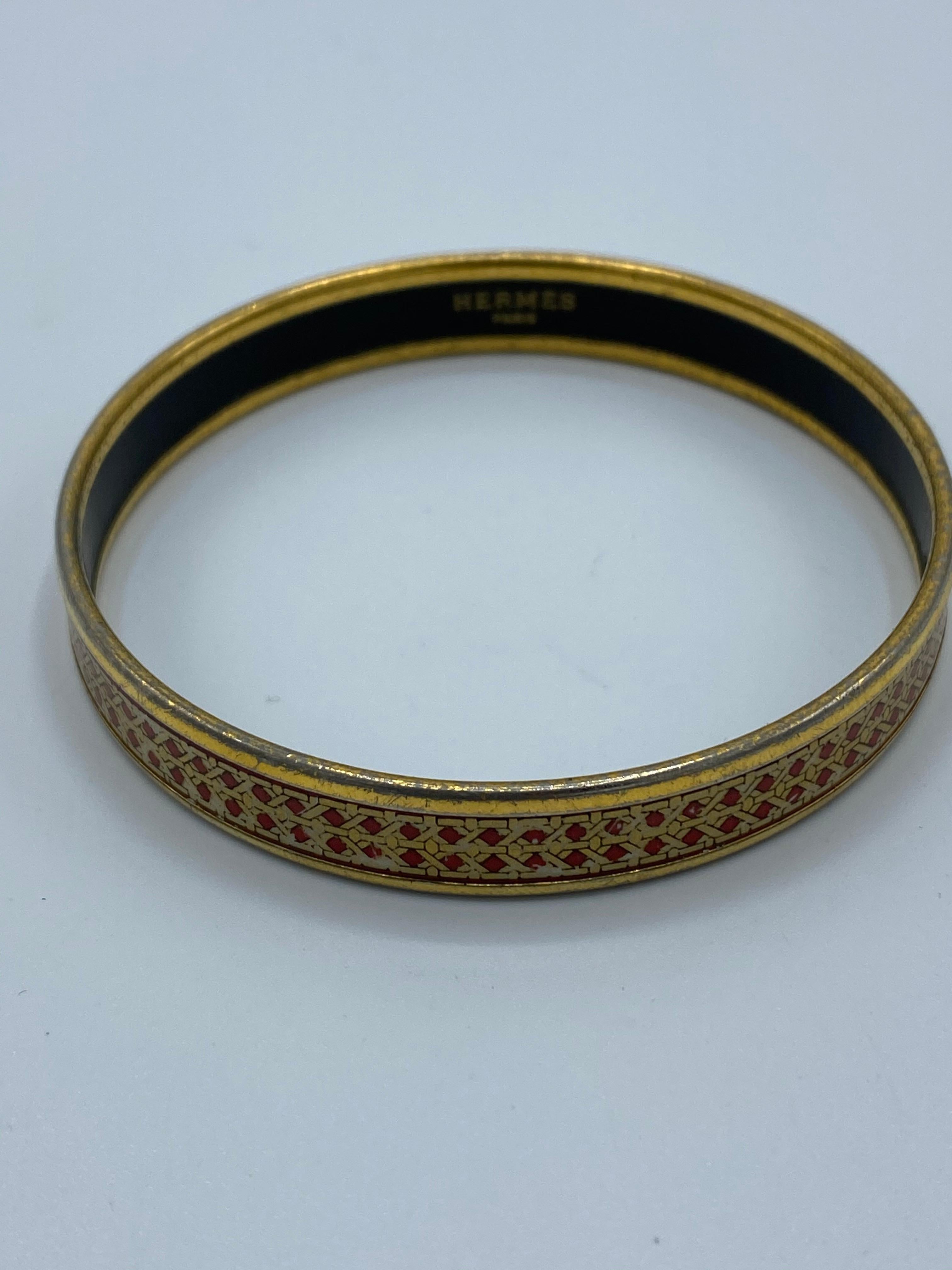 Product details:

Featuring gold tone hardware, enamel , red and gold geometric pattern design. Signed Hermes Paris. Made in Austria. Comes with the original Hermes box. Inner circumference is 7.5