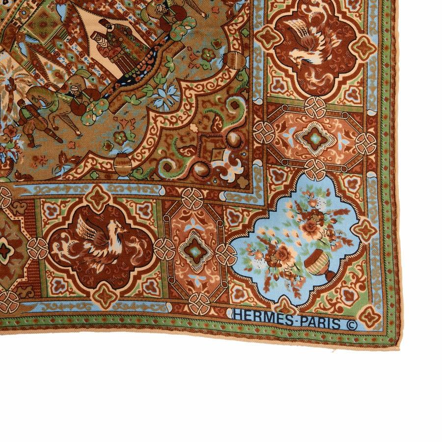 Hermes vintage shawl. The drawings represents marocain palaces in brown and blue towns. Its made of wool but as a vintage piece the fabric and  label is not on the shawl anymore, but theyr is the stamp 