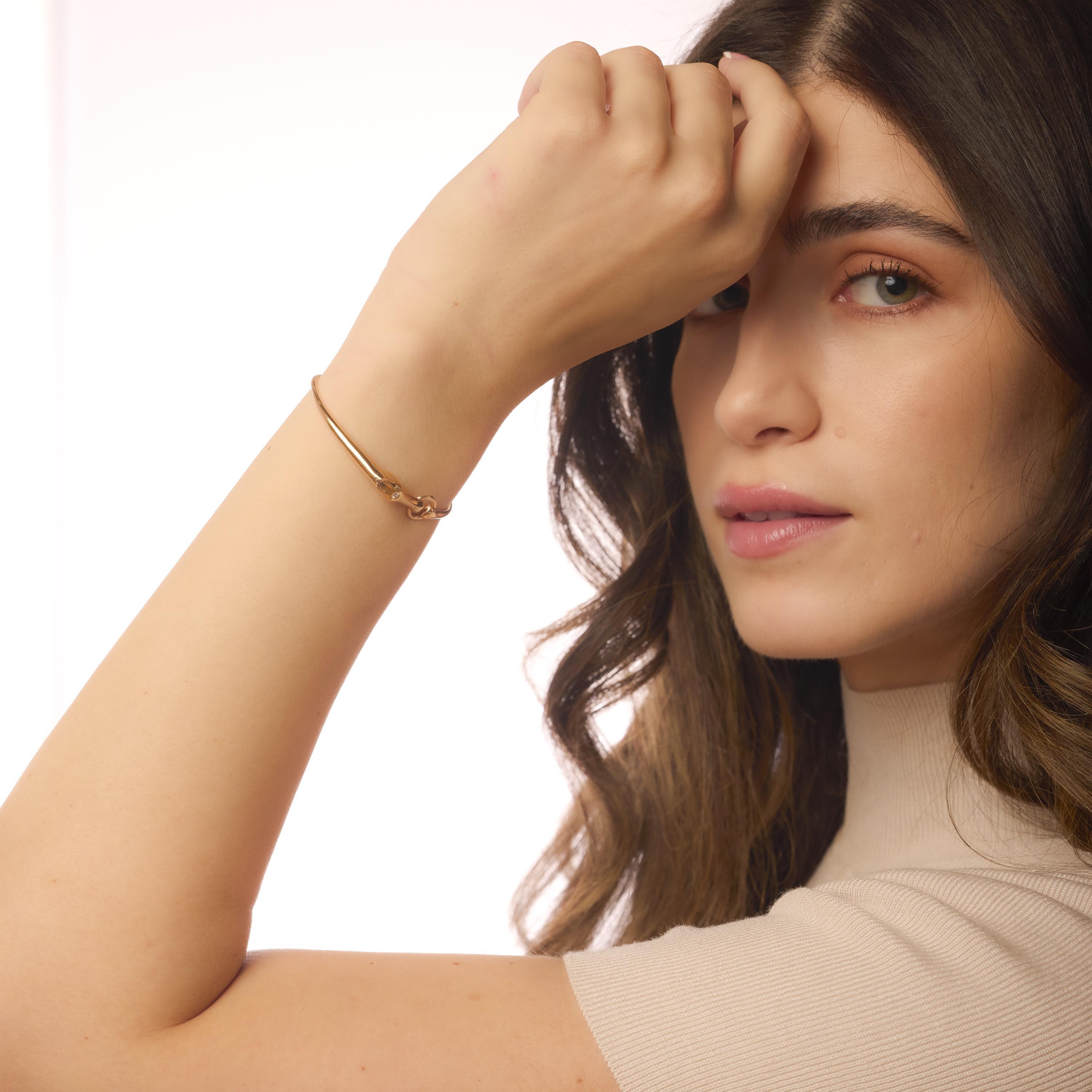 This vintage Hermès bangle in 18k rose gold showcases a sparkling D color diamond and impeccable French craftsmanship, blending elegance with everyday sophistication.