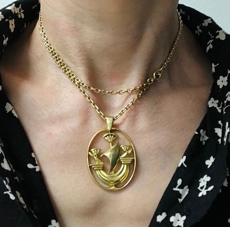 A rare 18k gold Hermes chain necklace with a ship pendant. The pendant is designed as a stylized sailboat staged in an oval frame. It's crafted of the polished gold and has amazingly clean lines.  A triangular loop completes the piece. This Hermes