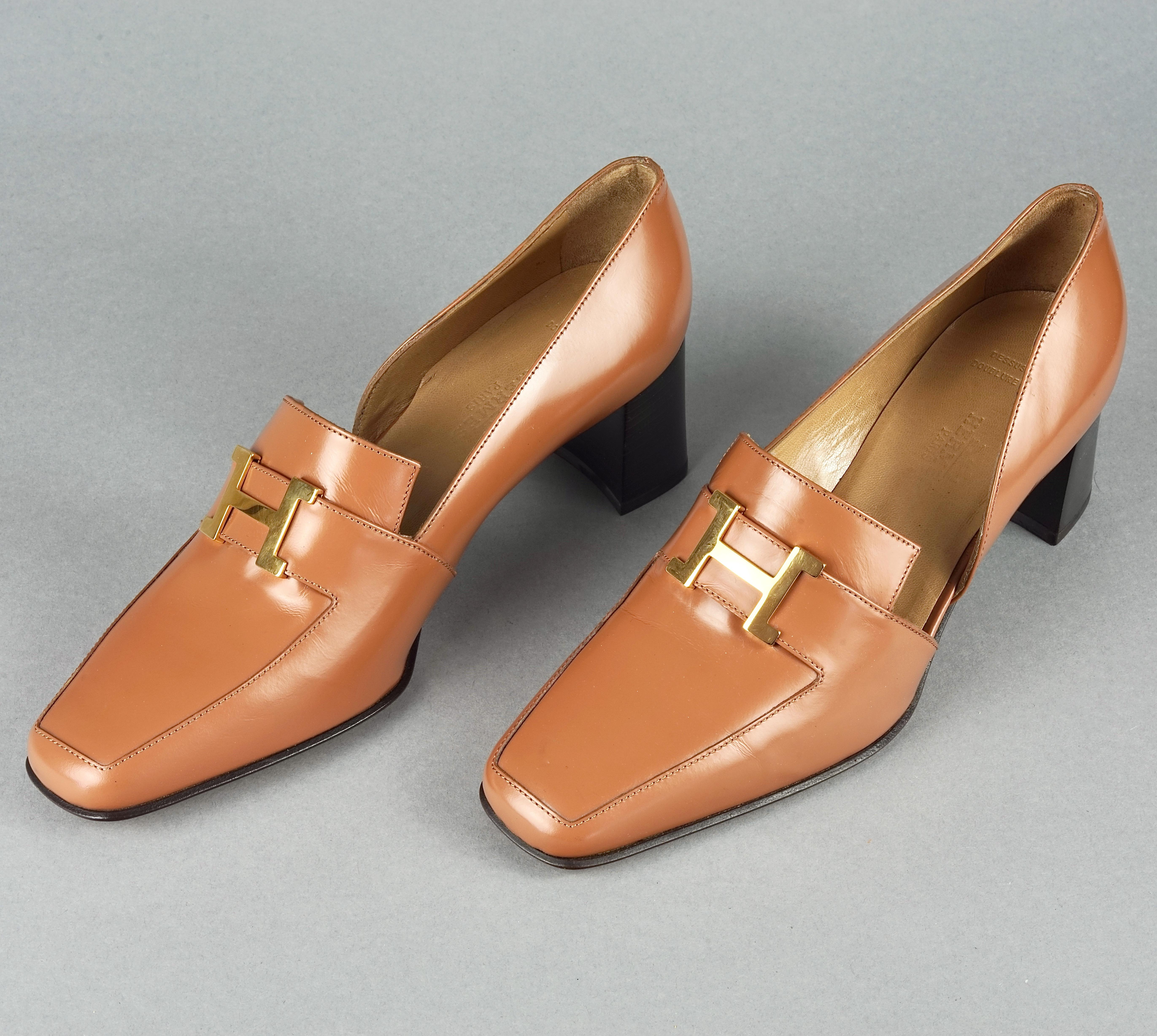 Vintage HERMES H Logo Leather Heel Loafer Shoes

Size: 37.5 EU

Features:
- 100% Authentic HERMES.
- Brown supple leather pumps/ heel loafers with gold metal H logo.
- Label reads: HERMES Made in Italy with S mark (Solde/ Sale).
- Size 37.5.
- Comes