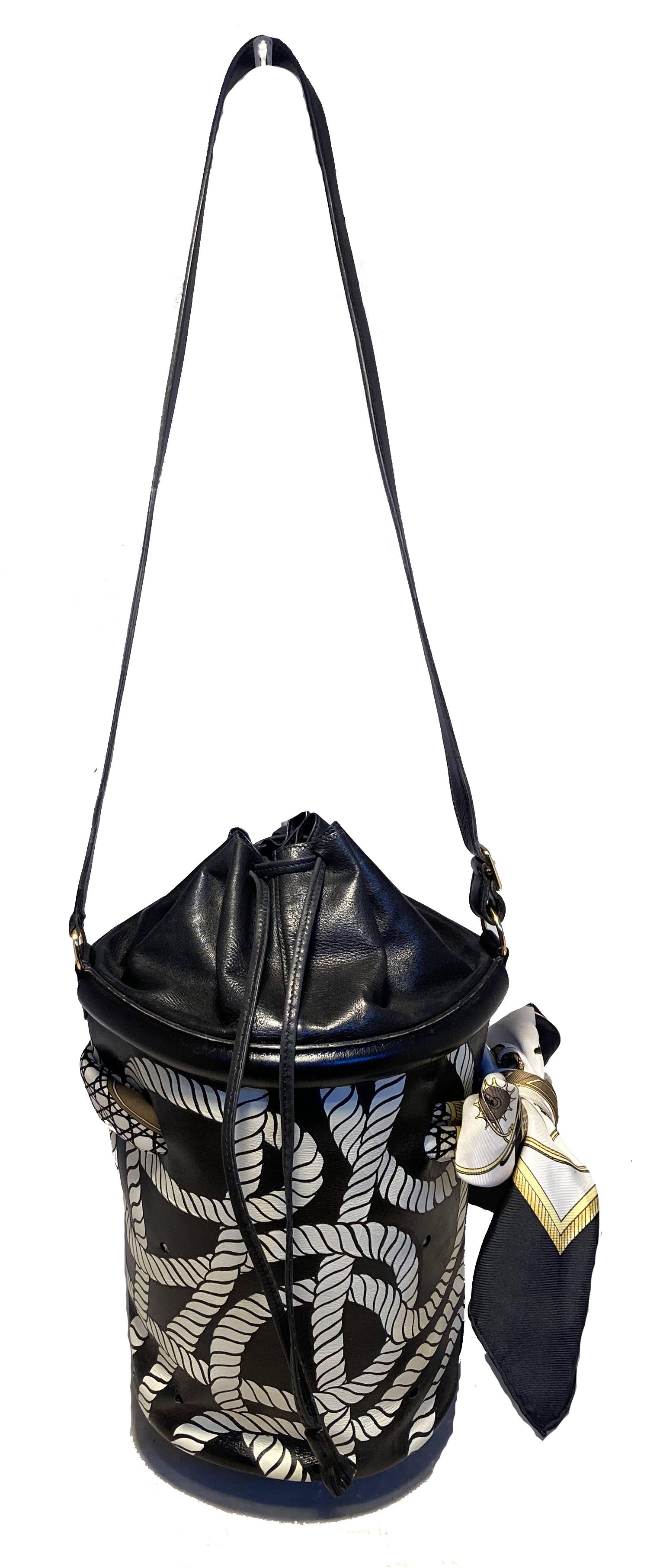 Vintage Hermes Hand Painted Ropes Bucket Bag in very good condition. Black box calf leather exterior with small holes and hand painted white ropes pattern throughout. Matching black and white Hermes silk scarf woven in and out of top edge and tied