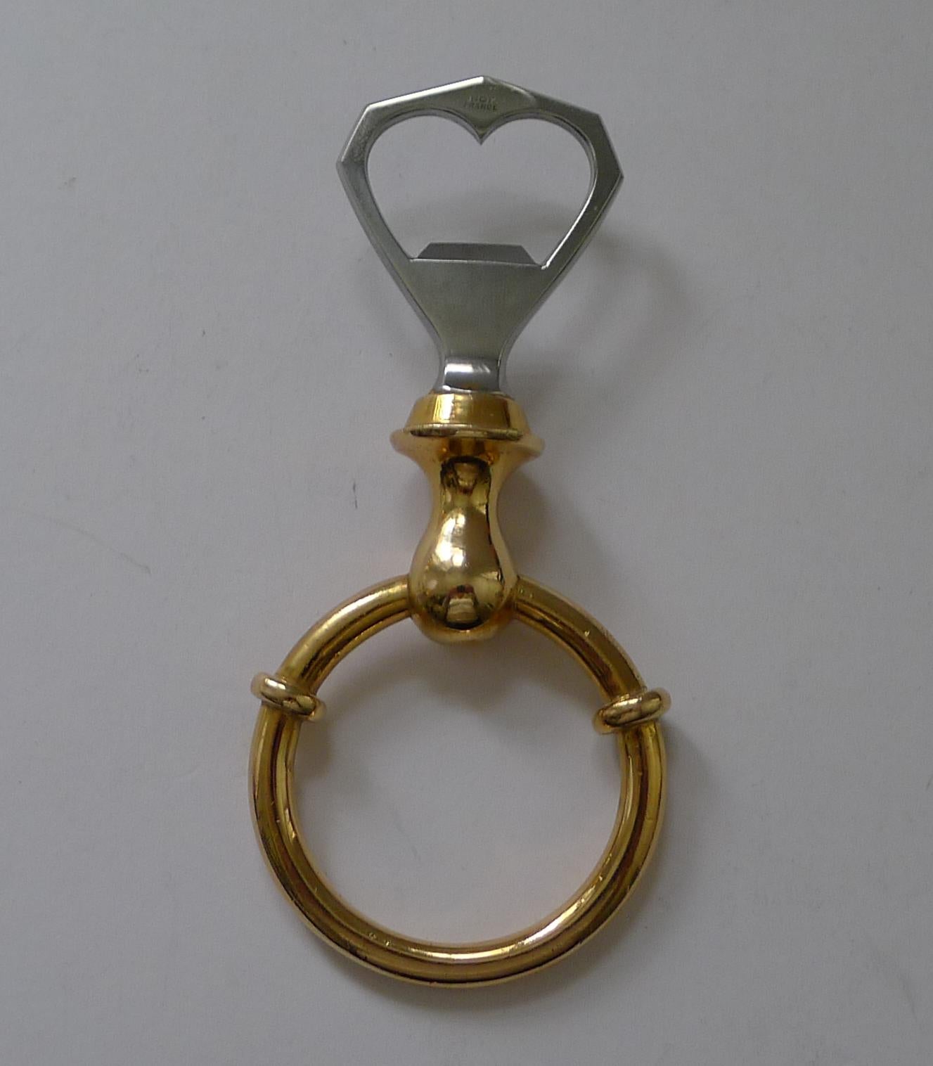 A stunning example of a vintage equestrian bottle opener dating to c.1970.

The handle is gold plated bronze fashioned in the form of a horse bit and the bottle opener itself made from Stainless Stell (Inox).  Made in France by one of the worlds