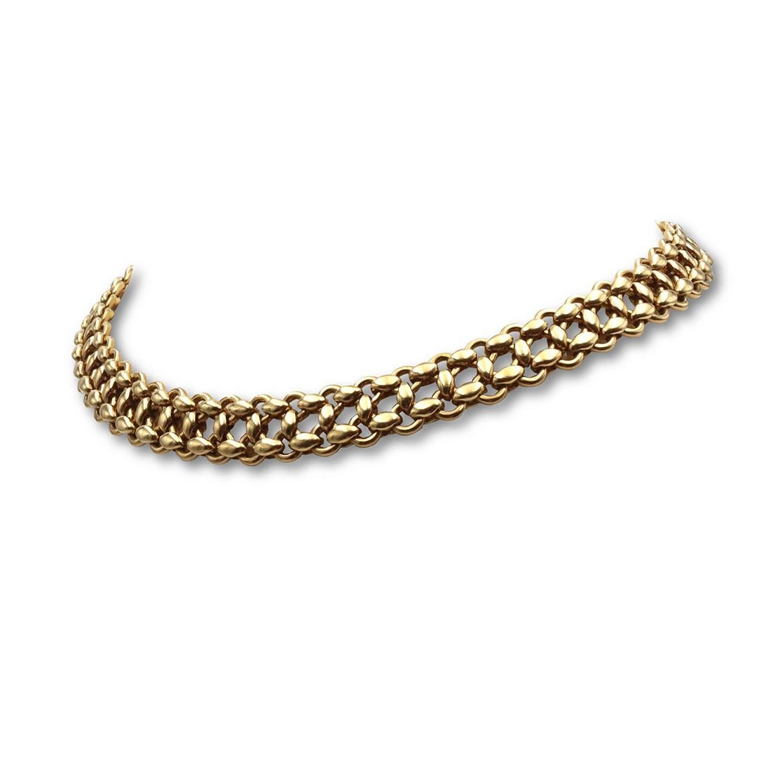 Authentic 'Inti' Hermès flexible necklace crafted in 18 karat yellow gold with two rows of links connected in an intricately woven pattern. The necklace measures 13 mm wide and 15 1/2 inches in length. Signed Hermes, 750, with serial number.  The