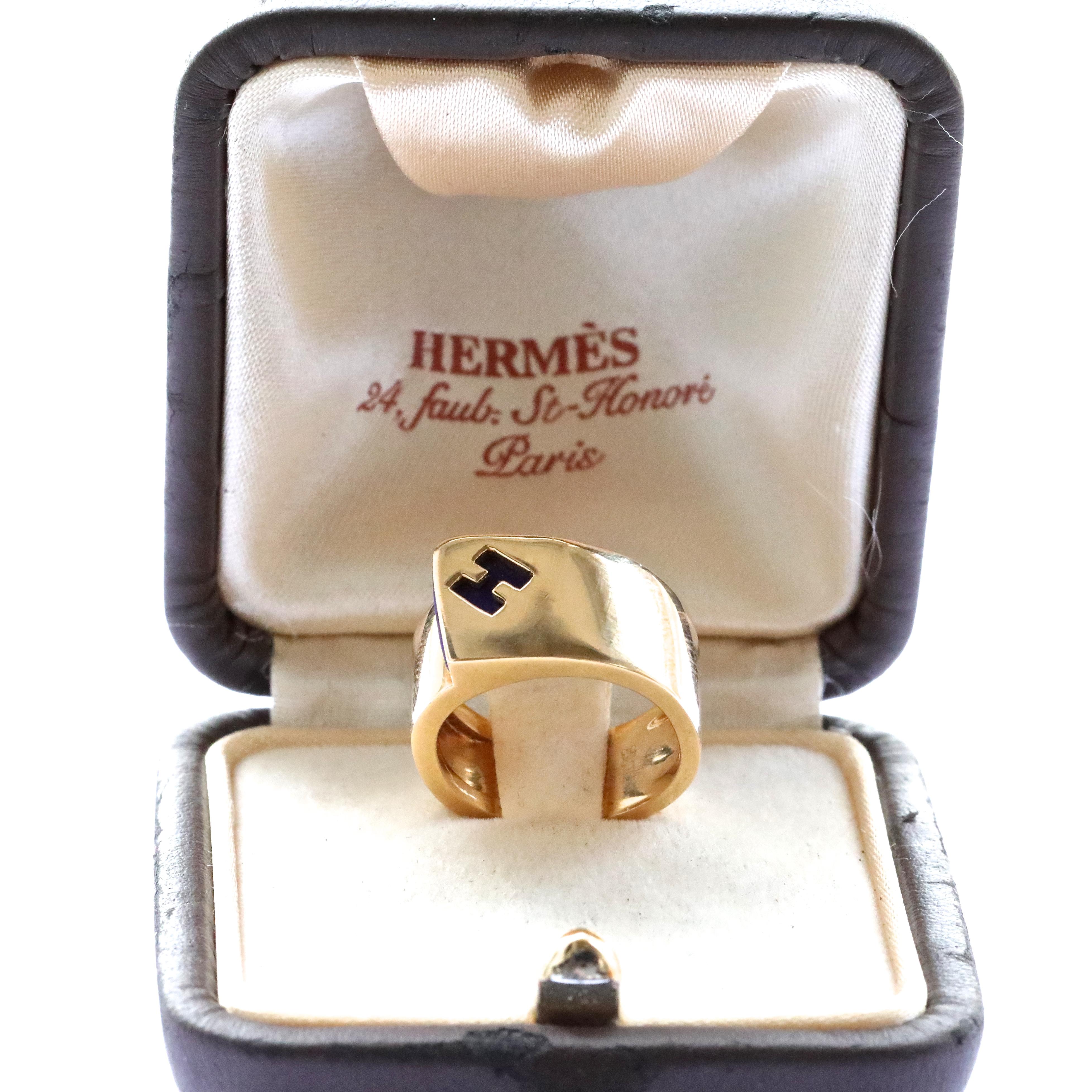 Bold and gold, this Hermes Lapis Lazuli 18k Gold Ring is very stylish and unique. The H is made from Lapis Lazuli that hides underneath the gold blanket. Wear this ring everyday or for a special occasion, you will not go wrong. Signed Hermes, serial