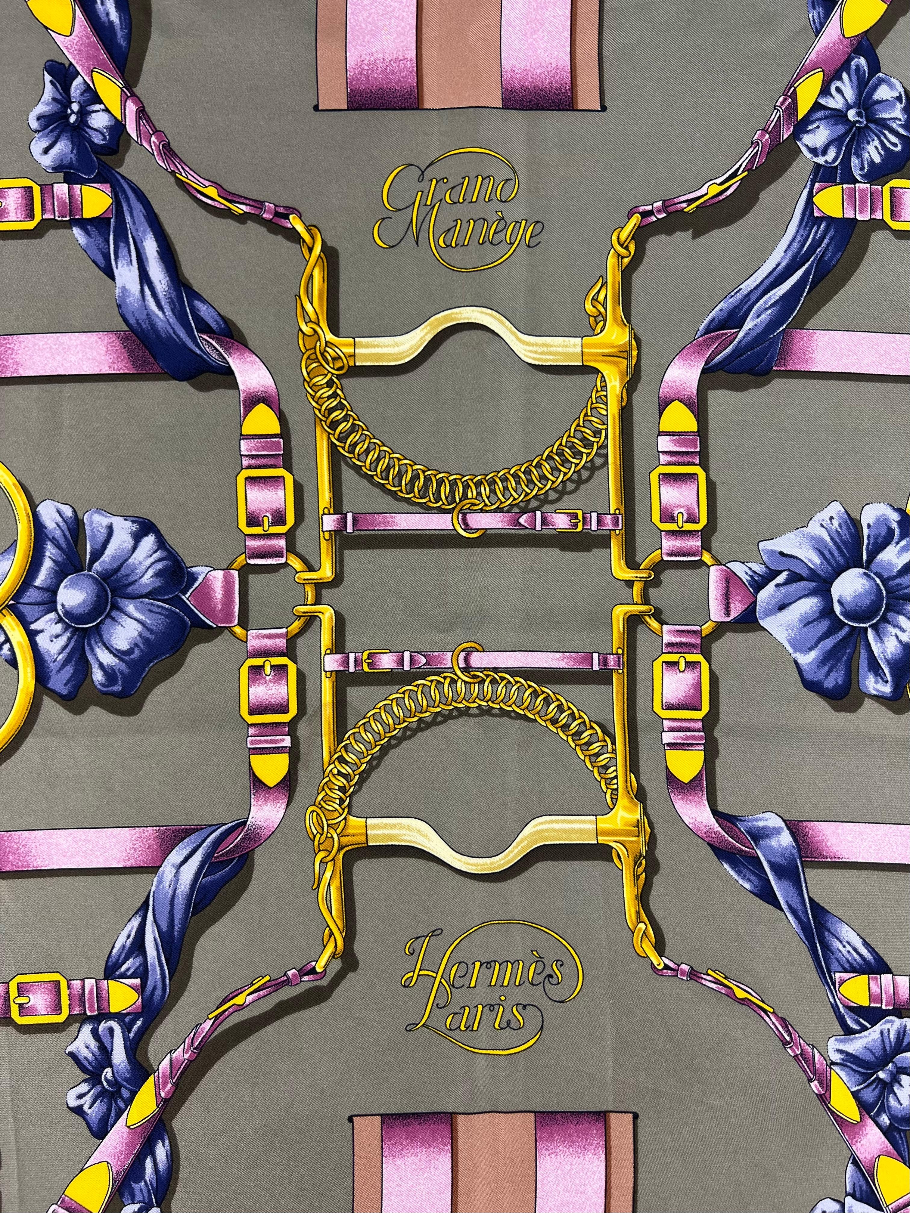 The scarf is designed by Henri d’Origny in 1990’s. It features yellow, green, pink and navy color pallet; belt, buckle and floral motif print. 