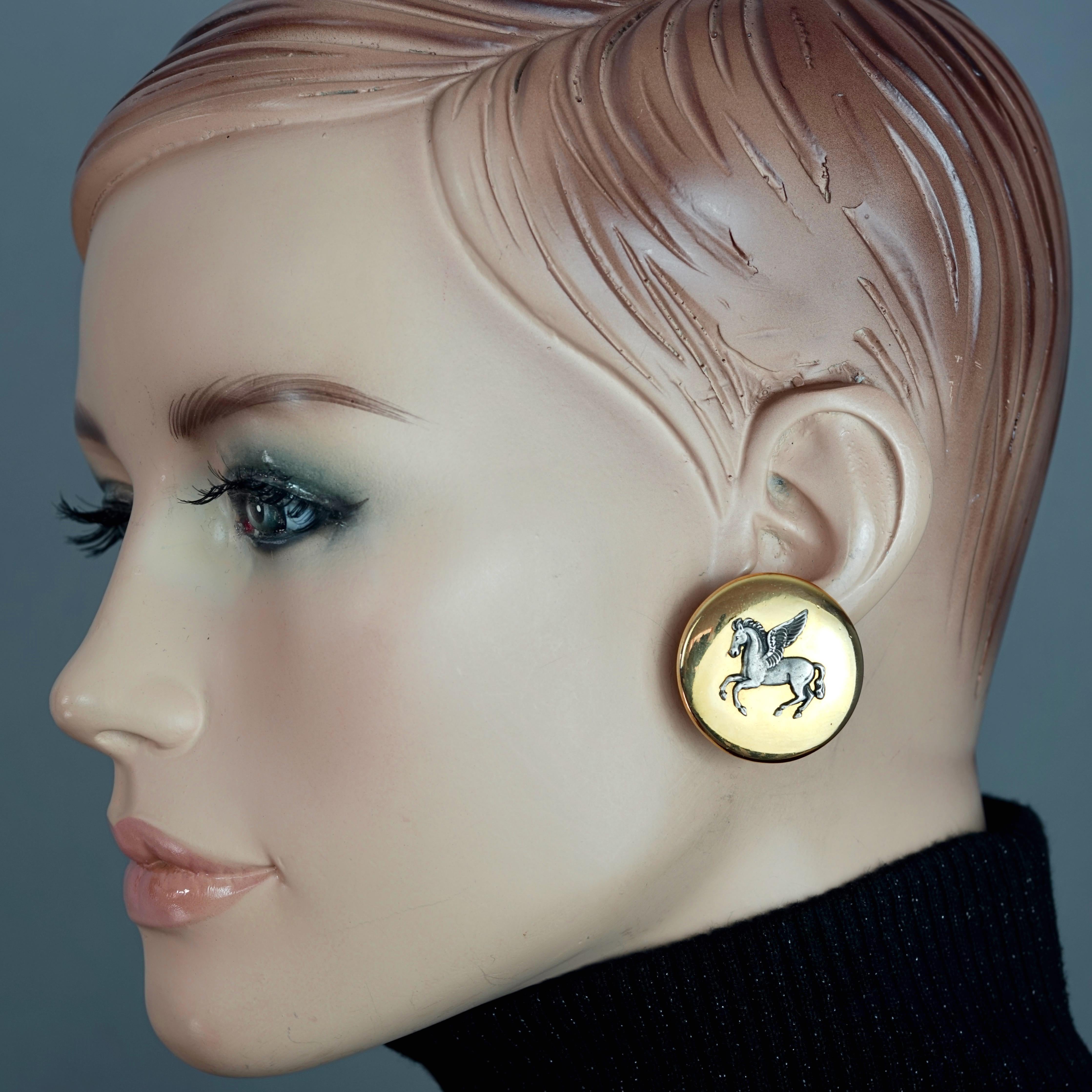 Vintage HERMES Pegasus Earrings

Measurements:
Height: 1.22 inches (3.1 cm)
Width: 1.22 inches (3.1 cm)
Weight per Earring: 13 grams

Features:
- 100% Authentic HERMES PARIS.
- Medallion earrings with embossed pegasus.
- Gold and silver tone