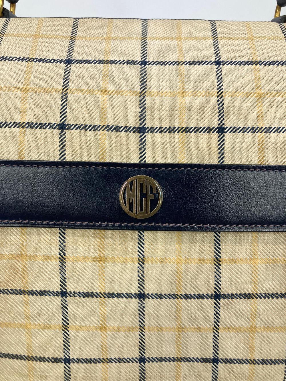 Vintage Hermes Plaid Canvas and Navy Leather Briefcase Tote in fair condition. Navy box calf leather with beige navy and yellow plaid canvas and gold hardware. Removable navy leather shoulder strap. Top handle and double buckle front closure opens