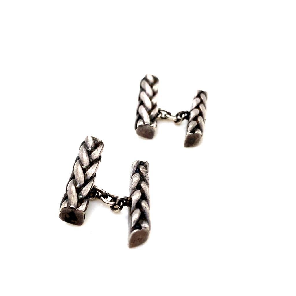 A pair of vintage Hermès silver cufflinks, circa 1950.

Each pair of chain link cufflinks is comprised of a braided silver bar  

Timeless and versatile these silver cufflinks are a smart and wearable example of the House of Hermes, perfect for