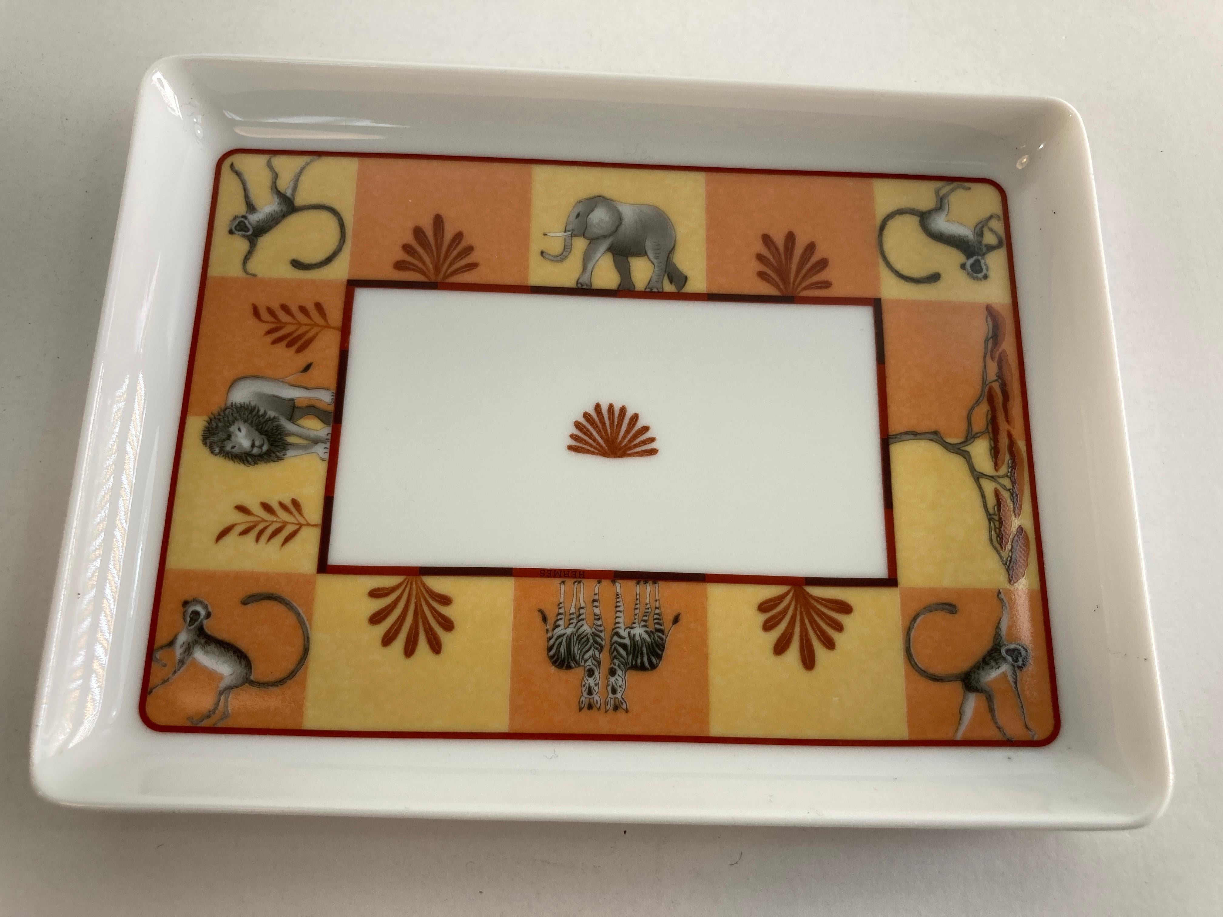 Hermès porcelain Africa orange small catchall trinket tray with Safari animals design.
Rare Vintage Hermes Porcelain Trinket Dish, Change Tray in the original box From late 1990's in the Africa pattern by Hermes.
This lovely vide poche features