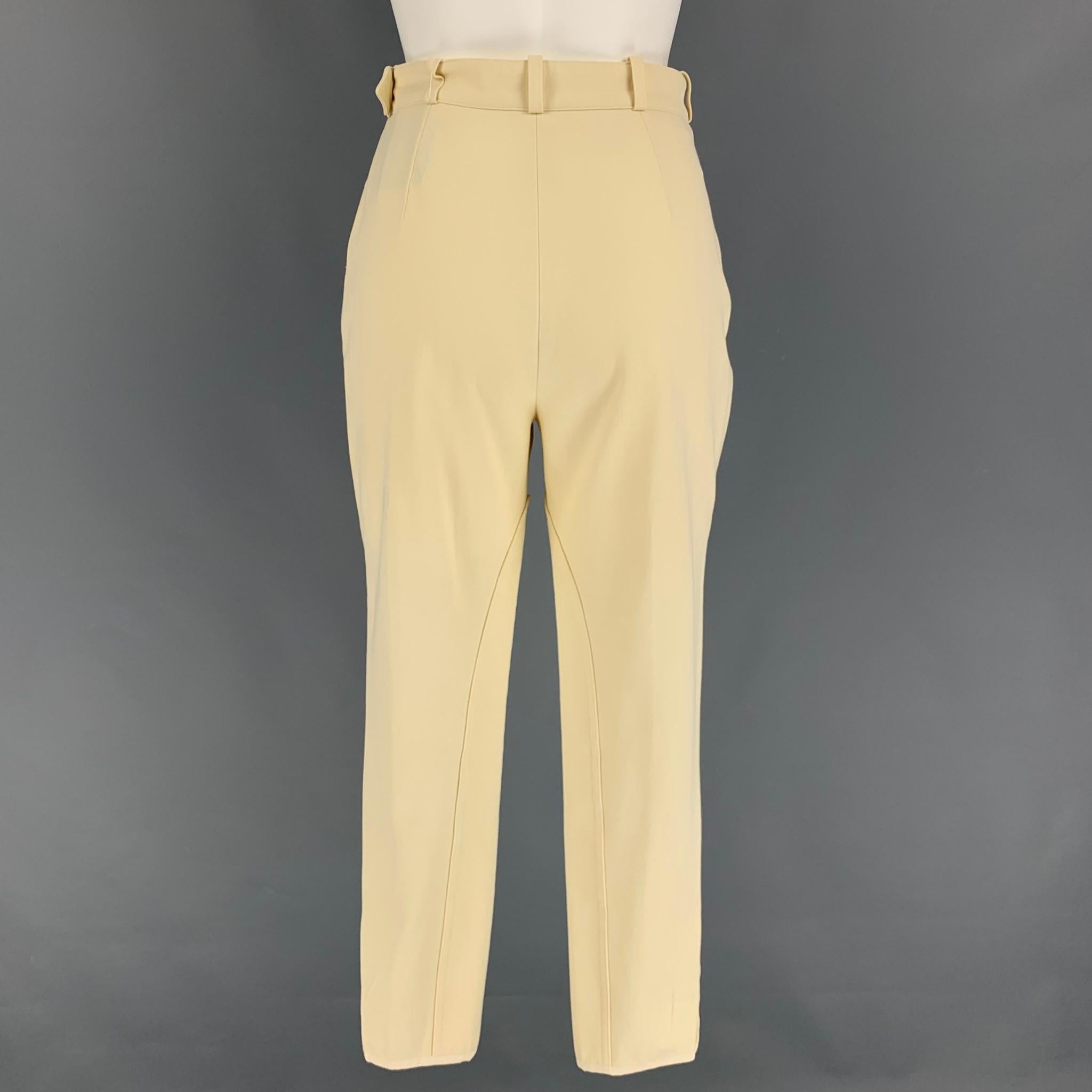 Vintage HERMES casual pants comes in a cream cotton featuring a jodhpurs style, gold tone hardware, gold tone buttons, front zipper pockets, belt loops, and a side zipper closure. Made in France. 

Very Good Pre-Owned Condition.
Marked: