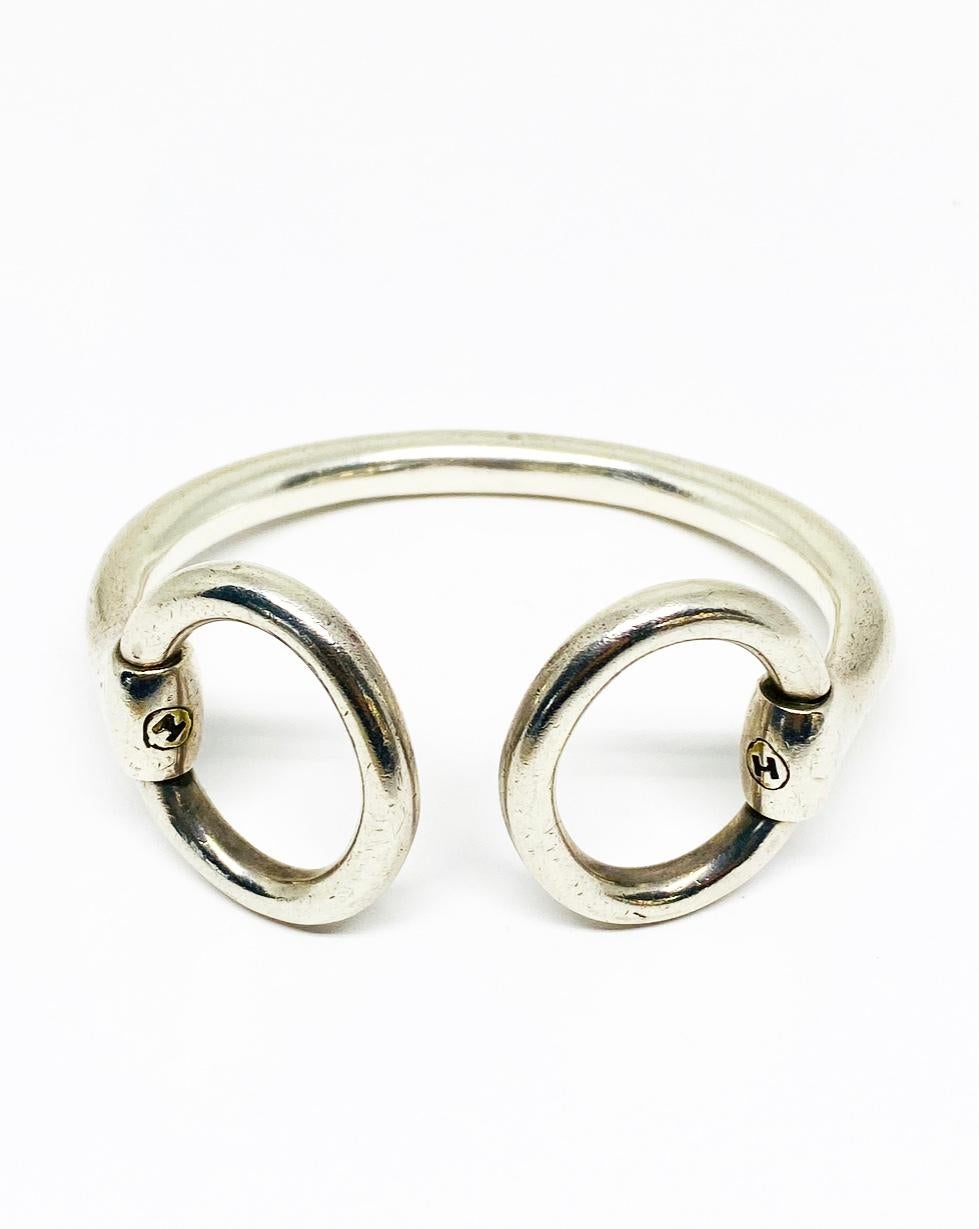Vintage Hermès Sterling Silver Bangle Bracelet

Product details:
Stamped with H on each side
Stamped with French marks for silver
Features two oval detail that opens, measures 1”x1.25” (each), 1.75” when opened 
The inner circumference is 6.25”
The