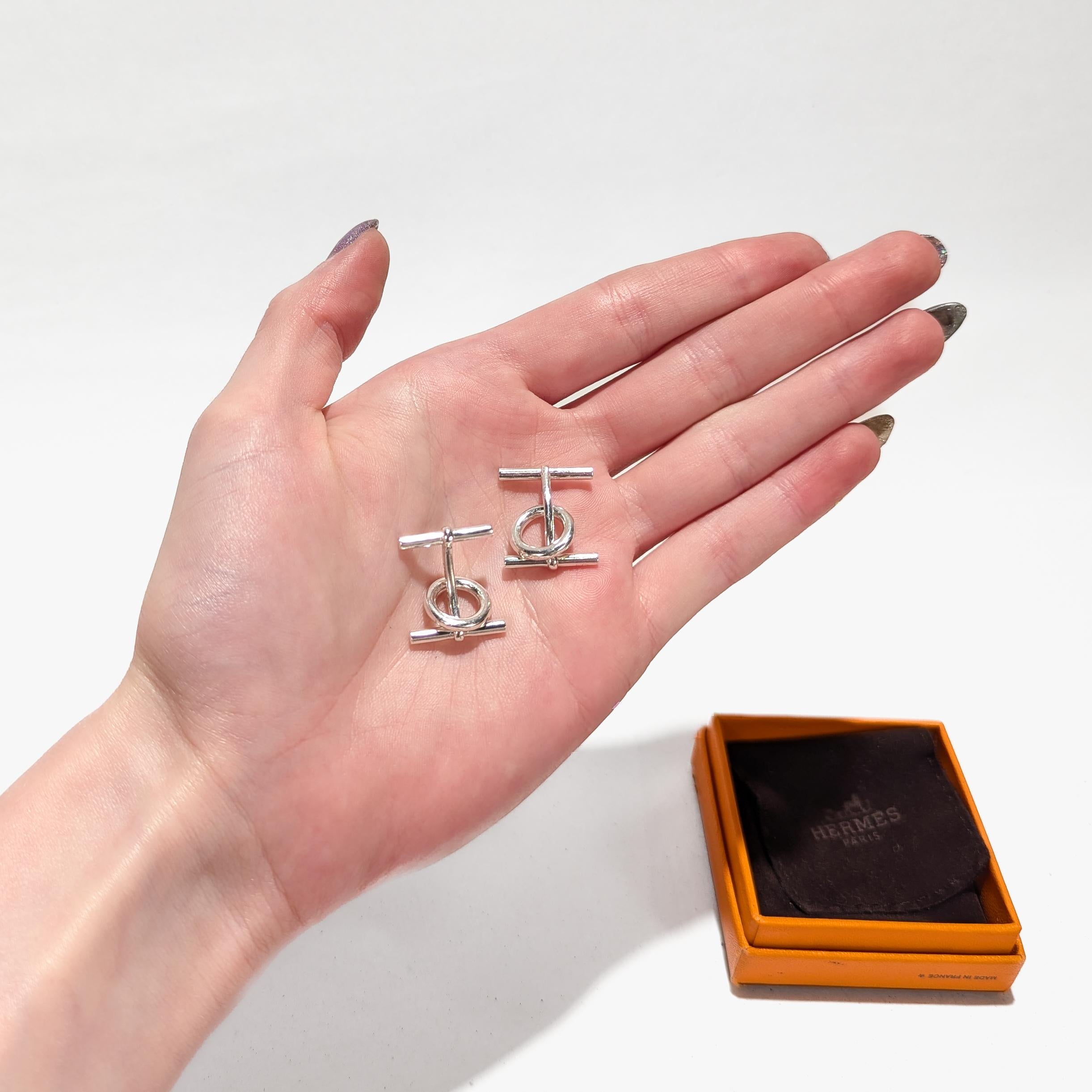 A fine pair of horse or riding themed cufflinks.

By Hermes.

In sterling silver.

Each in the form of a snaffle bit. 

Marked to the post of each for Hermes / AG925 / a French hallmark.

Simply a wonderful pair of cufflinks from Hermes!

Date:
20th